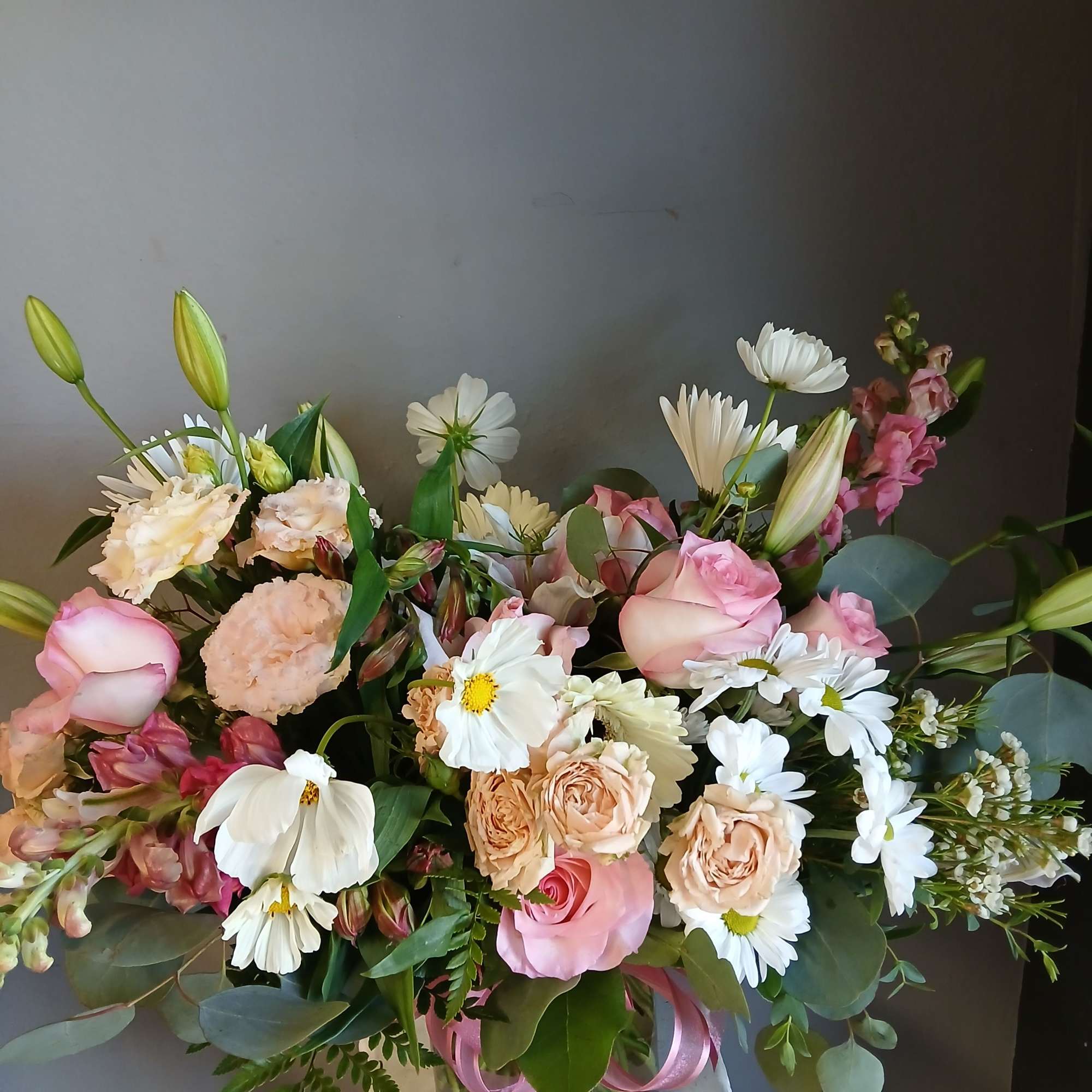 This beautiful flower arrangement of fresh mixed seasonal blooms is made by