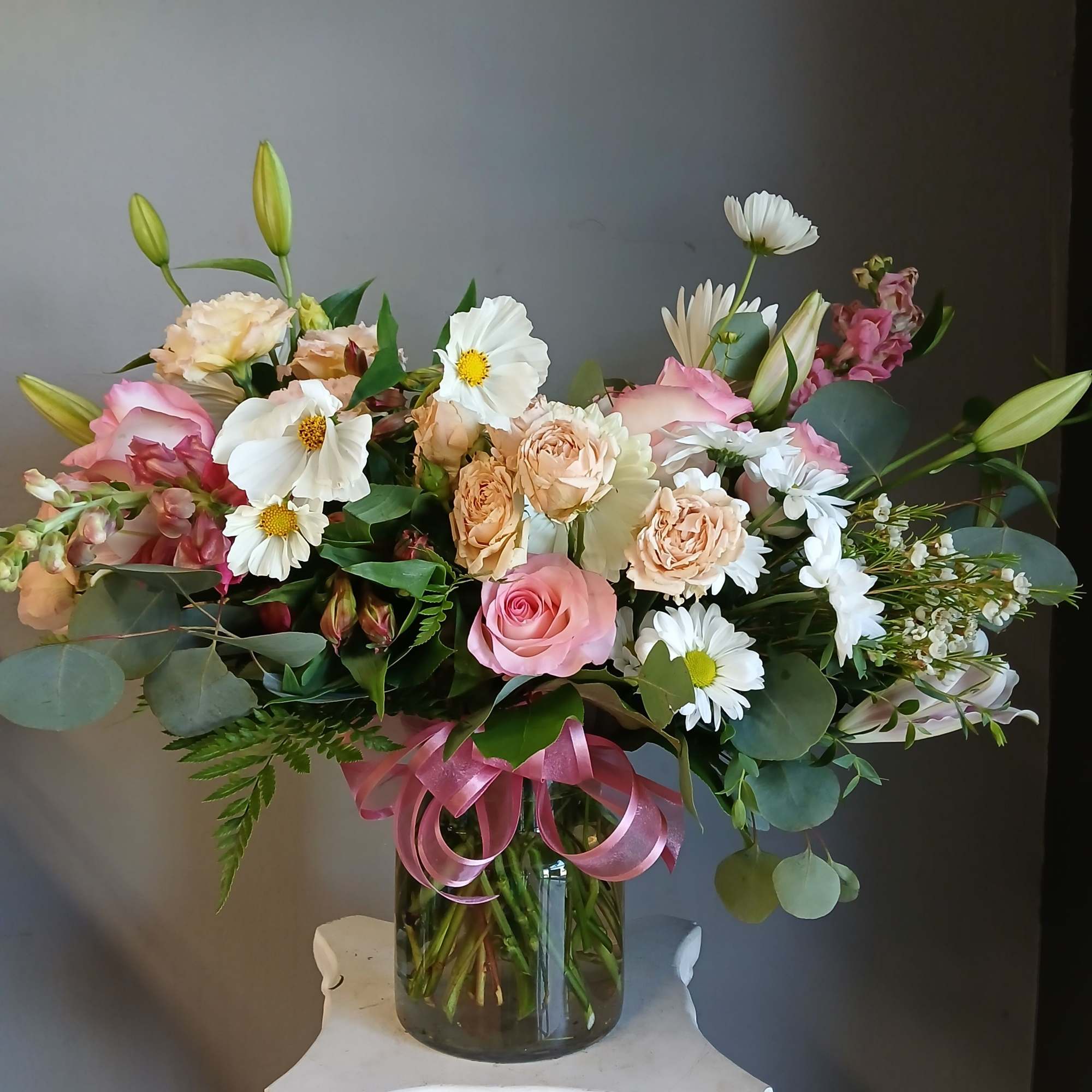 This beautiful flower arrangement of fresh mixed seasonal blooms is made by