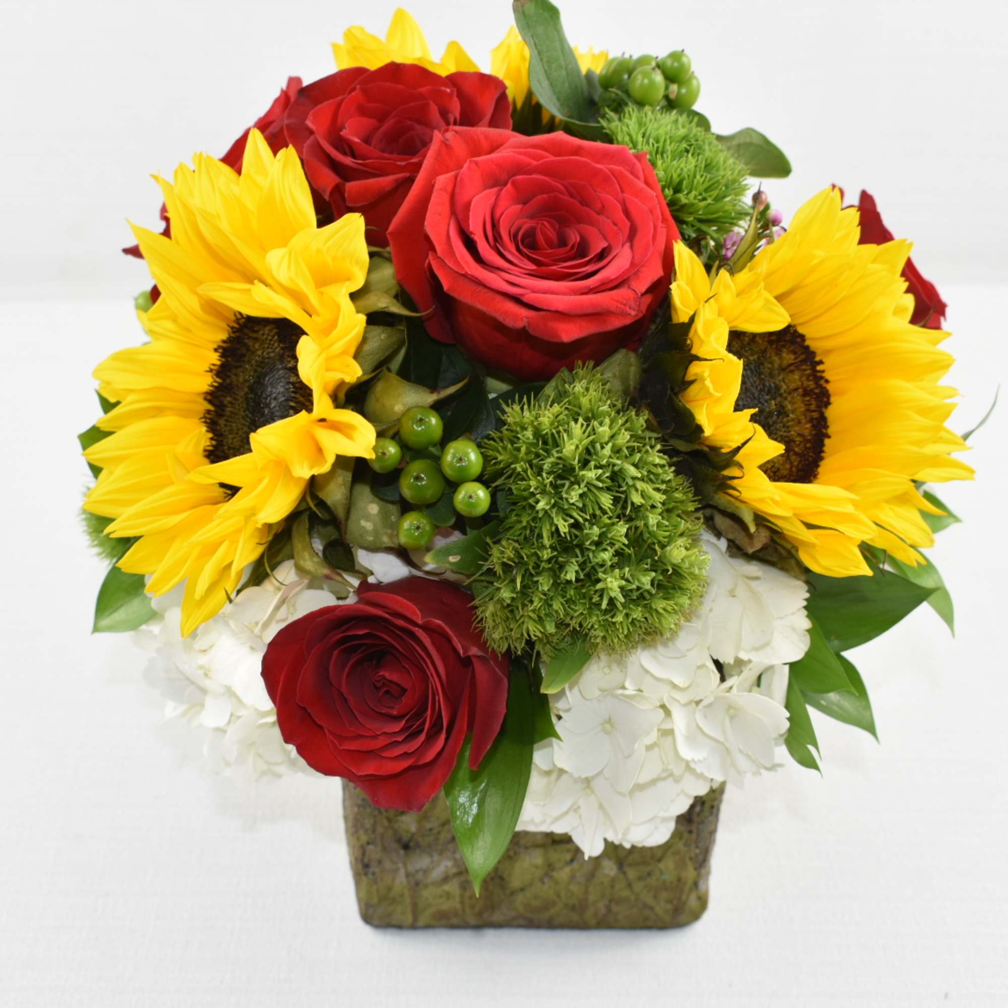 Rustic ceramic vase perfectly arrange with greenery, white hydrangeas, sunflowers and lastly