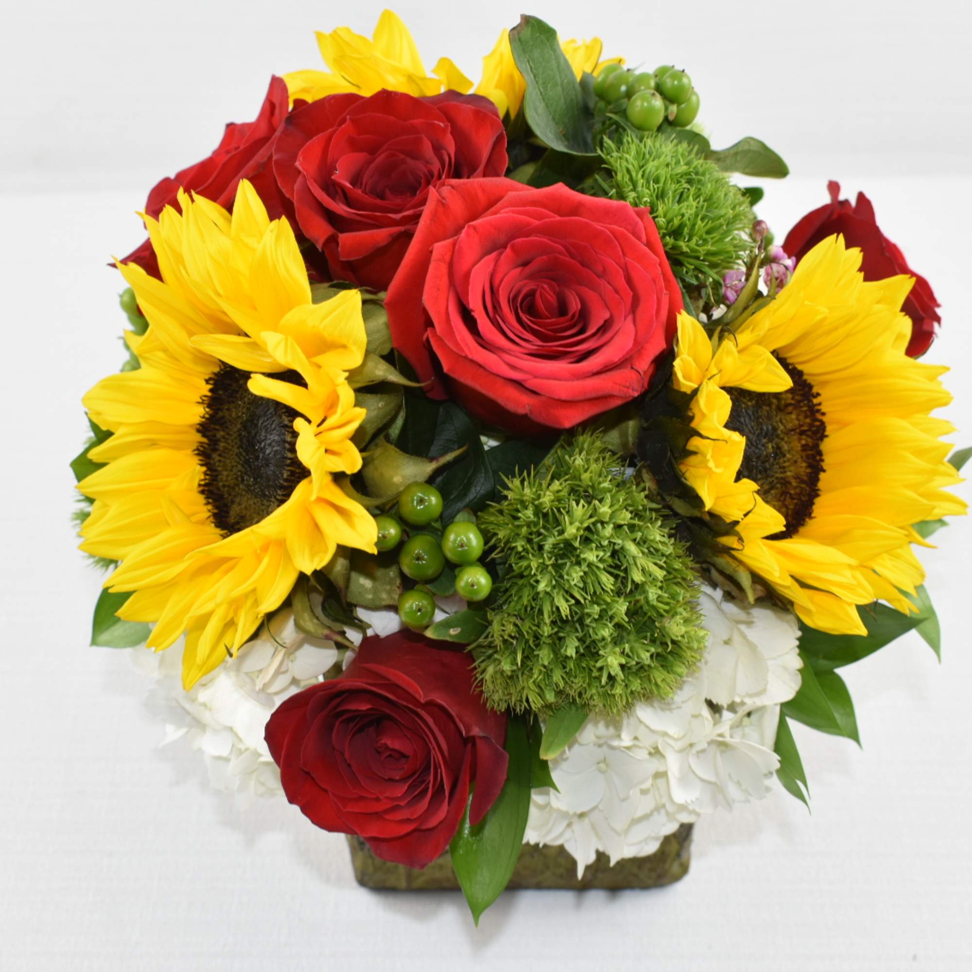 Rustic ceramic vase perfectly arrange with greenery, white hydrangeas, sunflowers and lastly