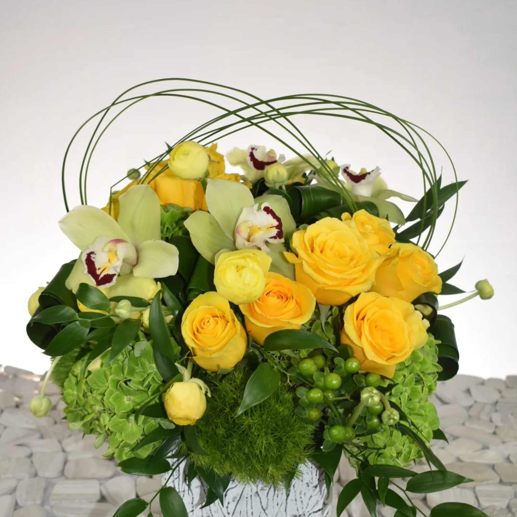 This arrangement comes in a white rustic ceramic vase 
With green hydrangeas