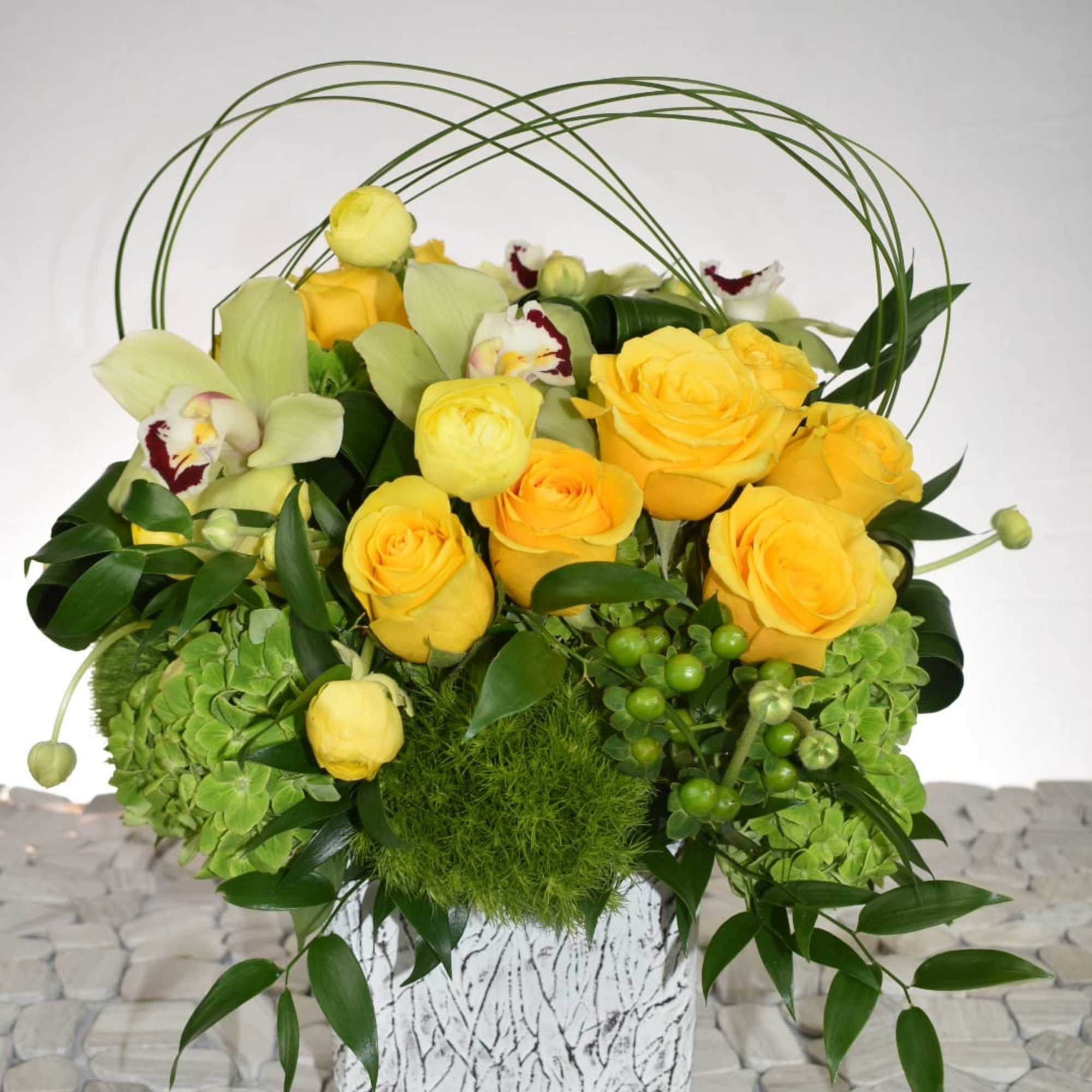 This arrangement comes in a white rustic ceramic vase 
With green hydrangeas