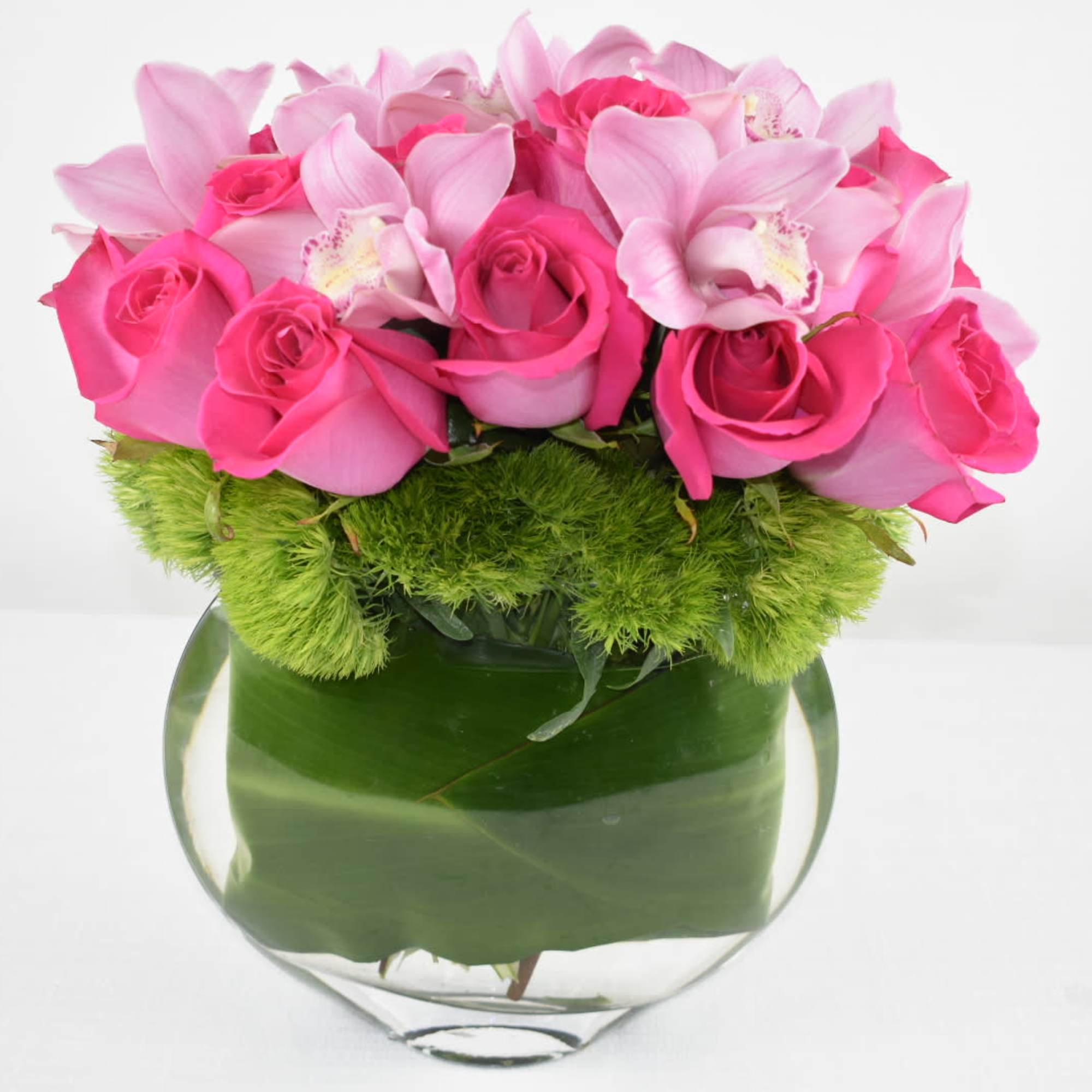 Unique glass vase well arranged with Hot pink Ecuadorian roses and pink