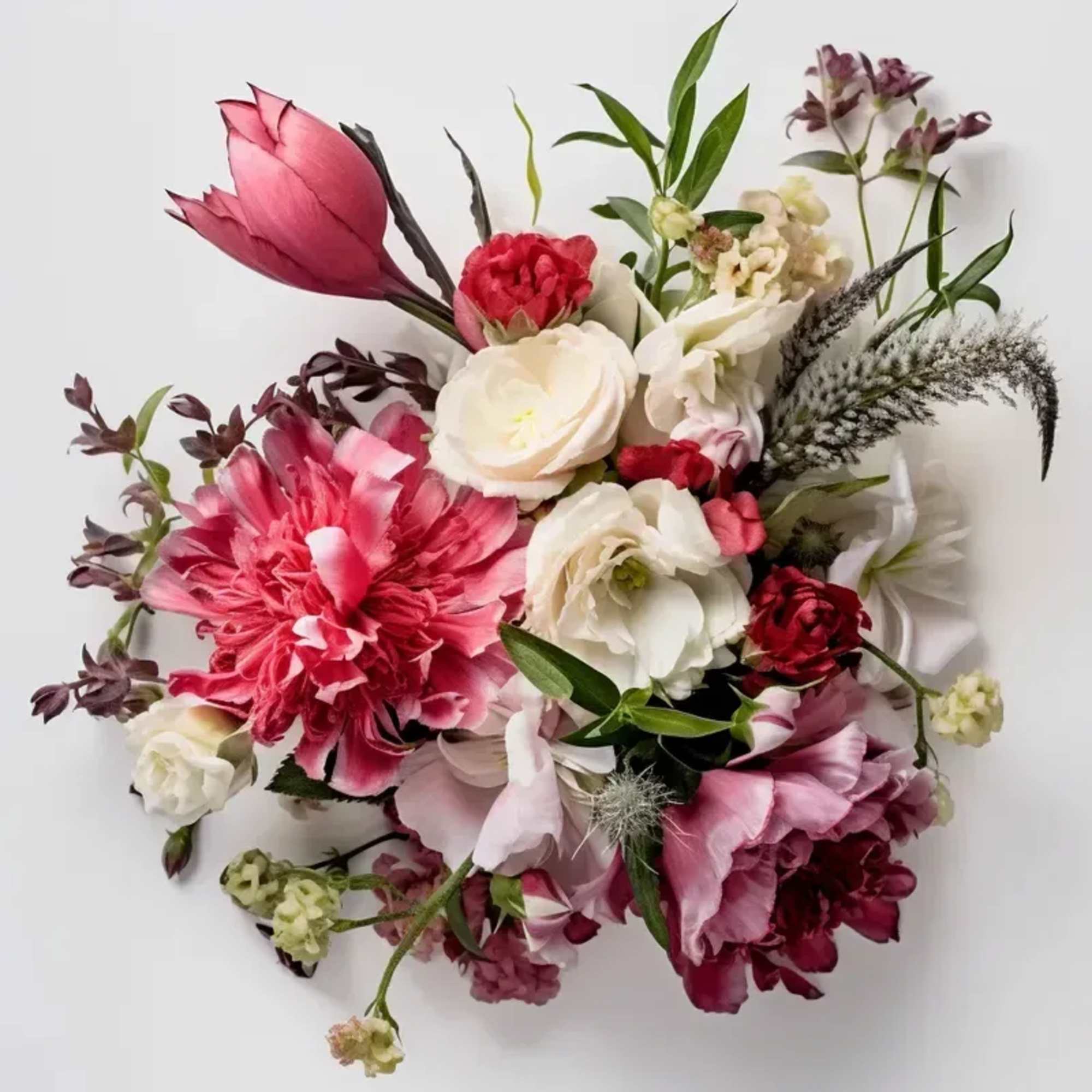An arrangement of seasonal blooms Anniversary arranged no vase. PLEASE NOTE: Flower