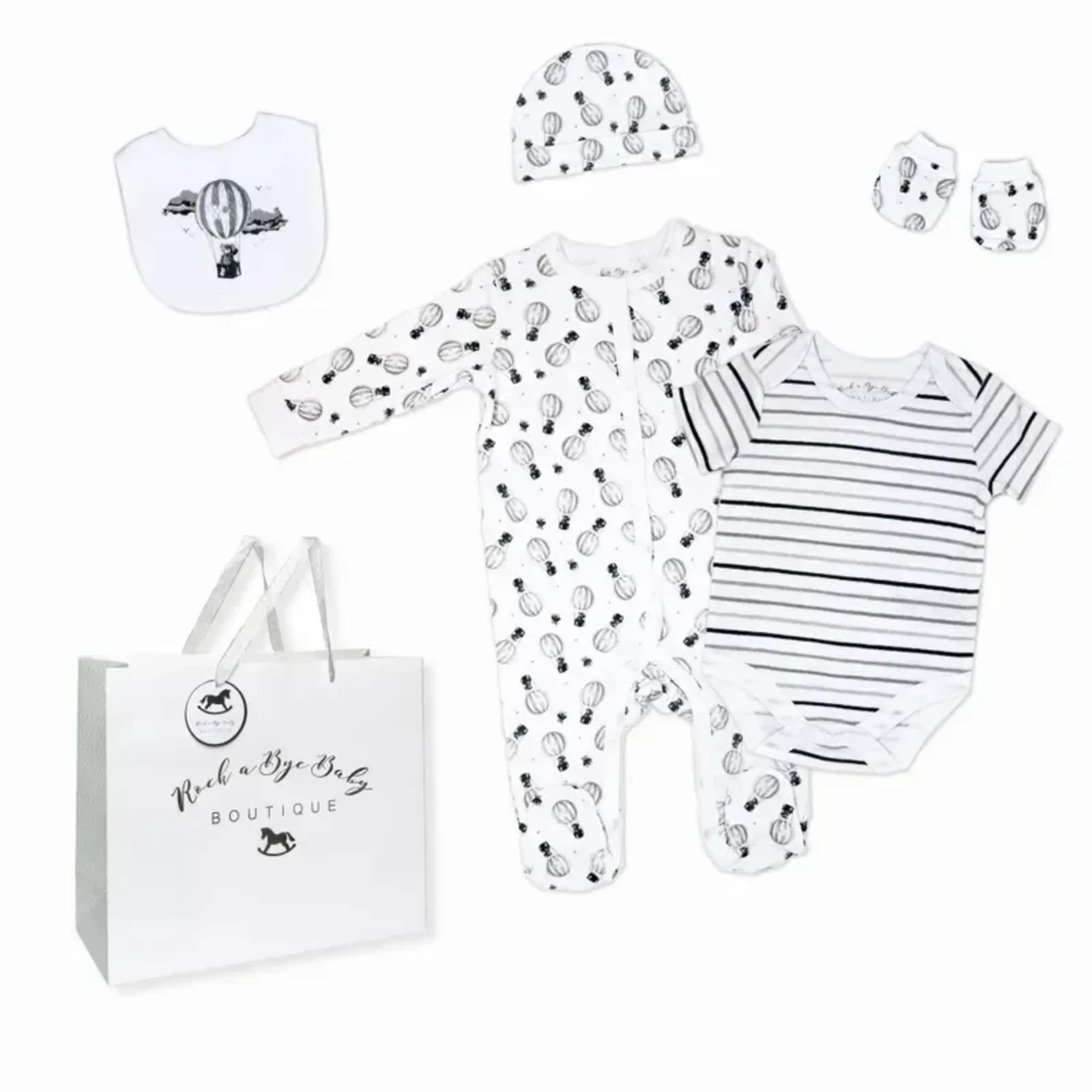 Soft neutral tones and thoughtful essentials make this baby gift set a