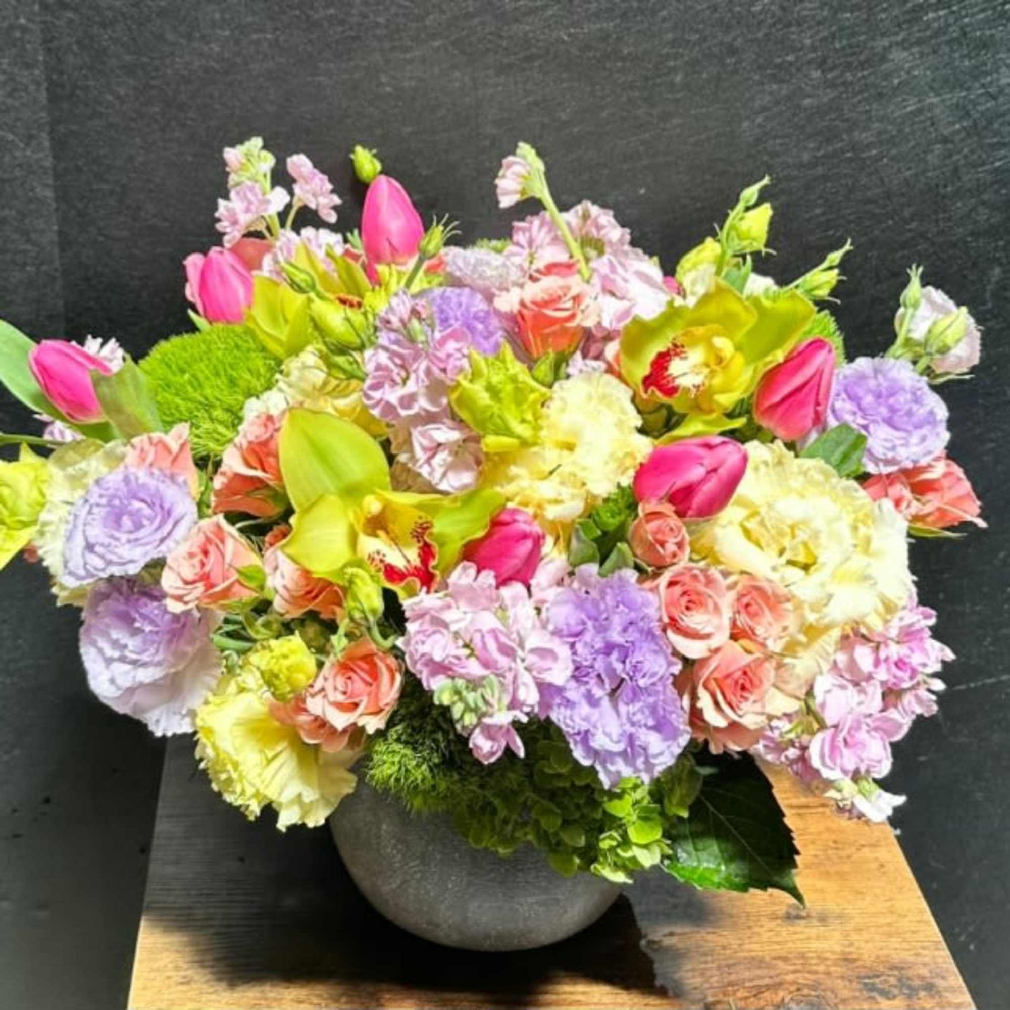 A lively, garden-style flower arrangement that reads joyful and celebratory, perfect as