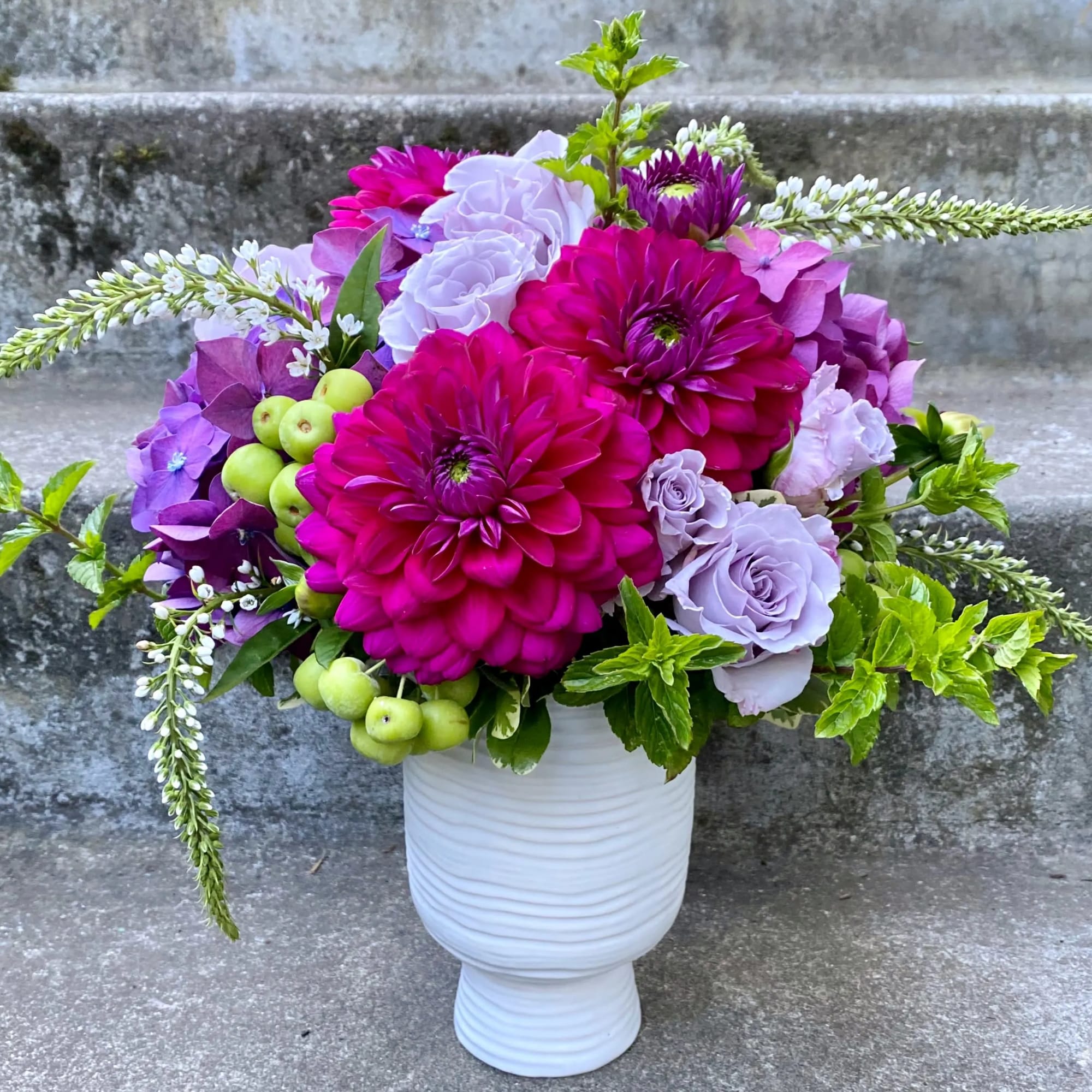 A Designer's Choice mixed floral arrangement featuring summer flowers such as dahlias