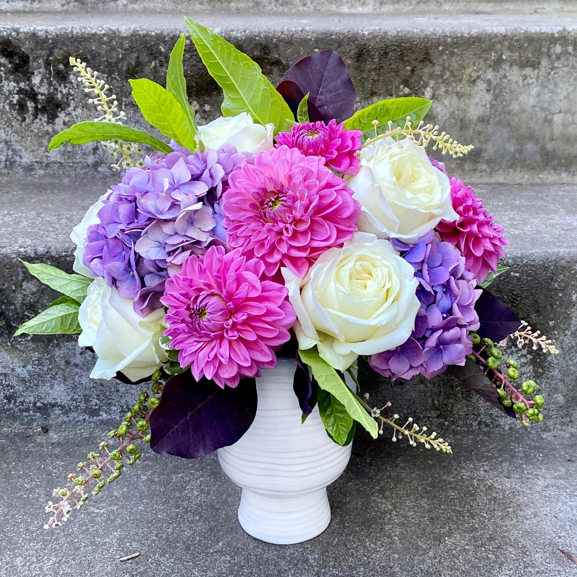 A Designer's Choice mixed floral arrangement featuring summer flowers such as dahlias