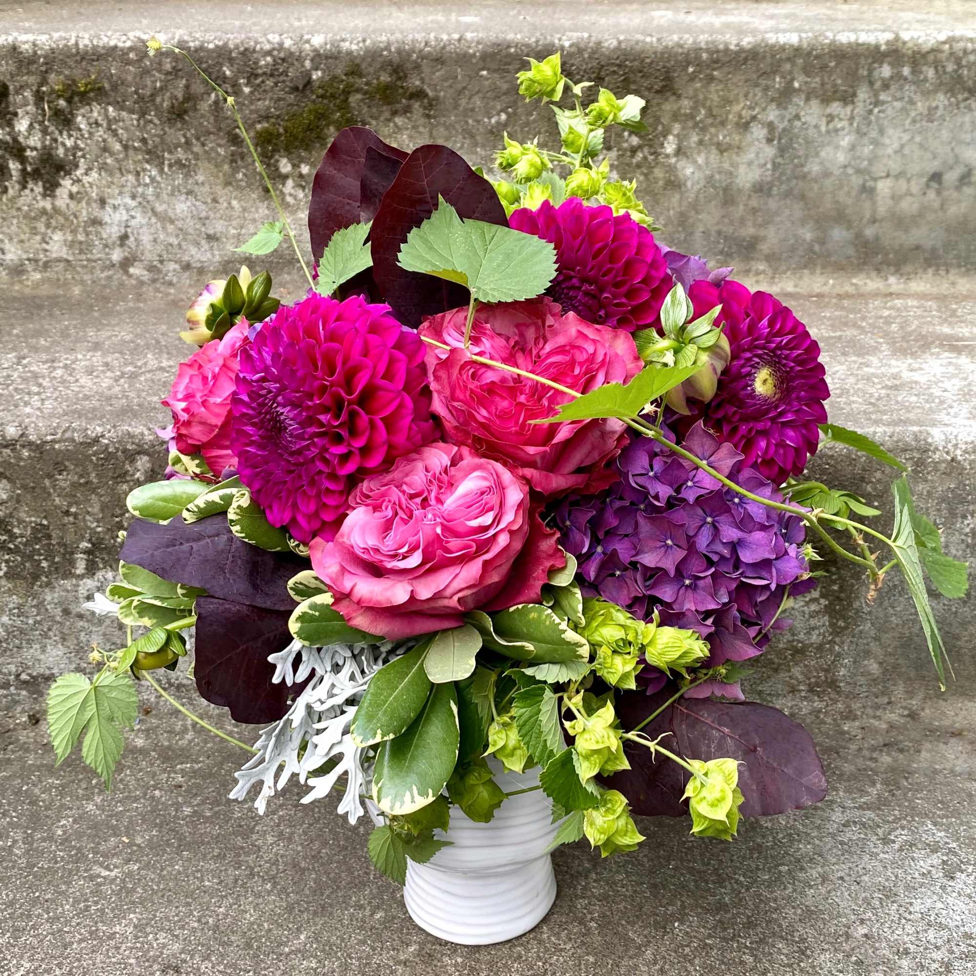 A Designer's Choice mixed floral arrangement featuring summer flowers such as dahlias