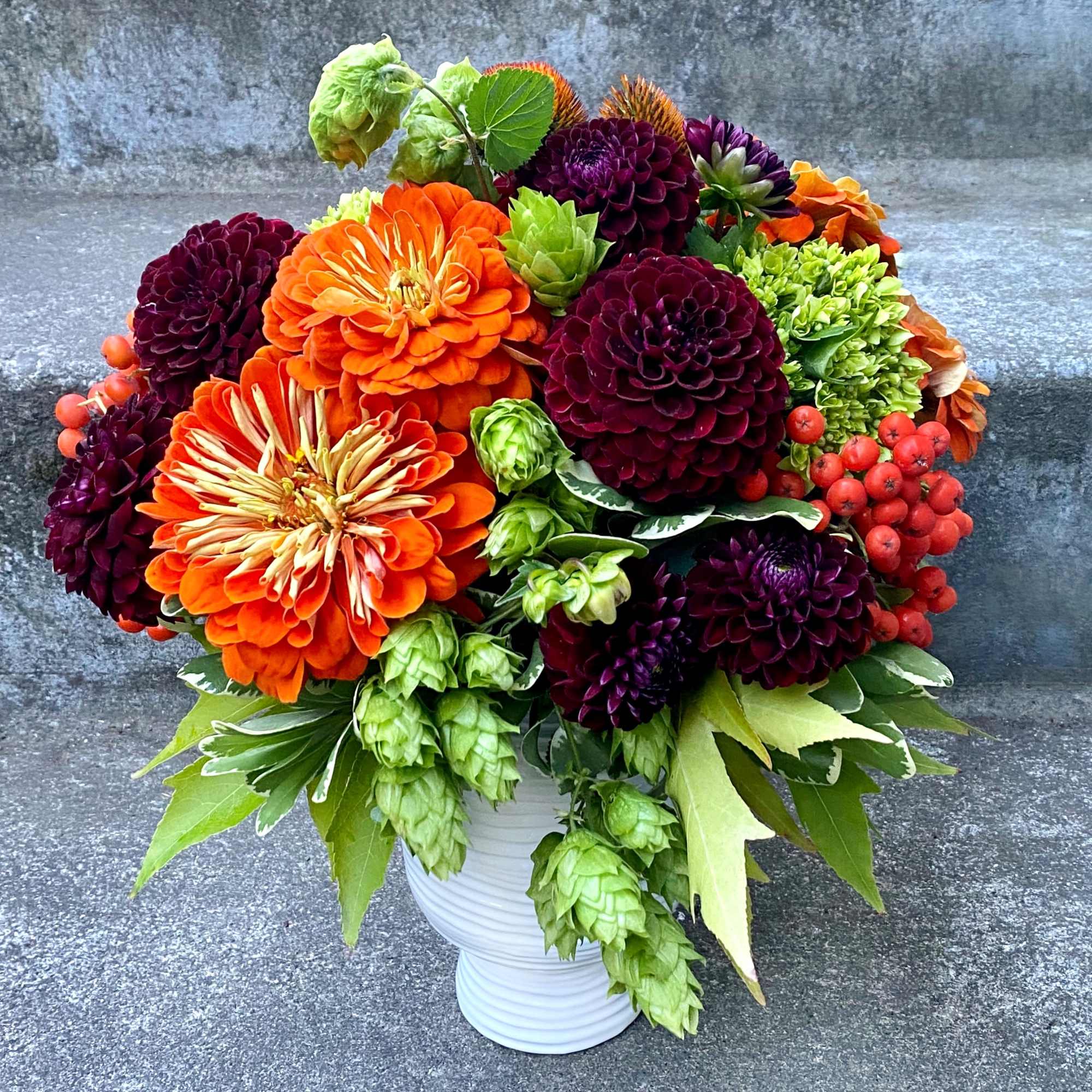 A Designer's Choice mixed floral arrangement featuring summer flowers such as dahlias