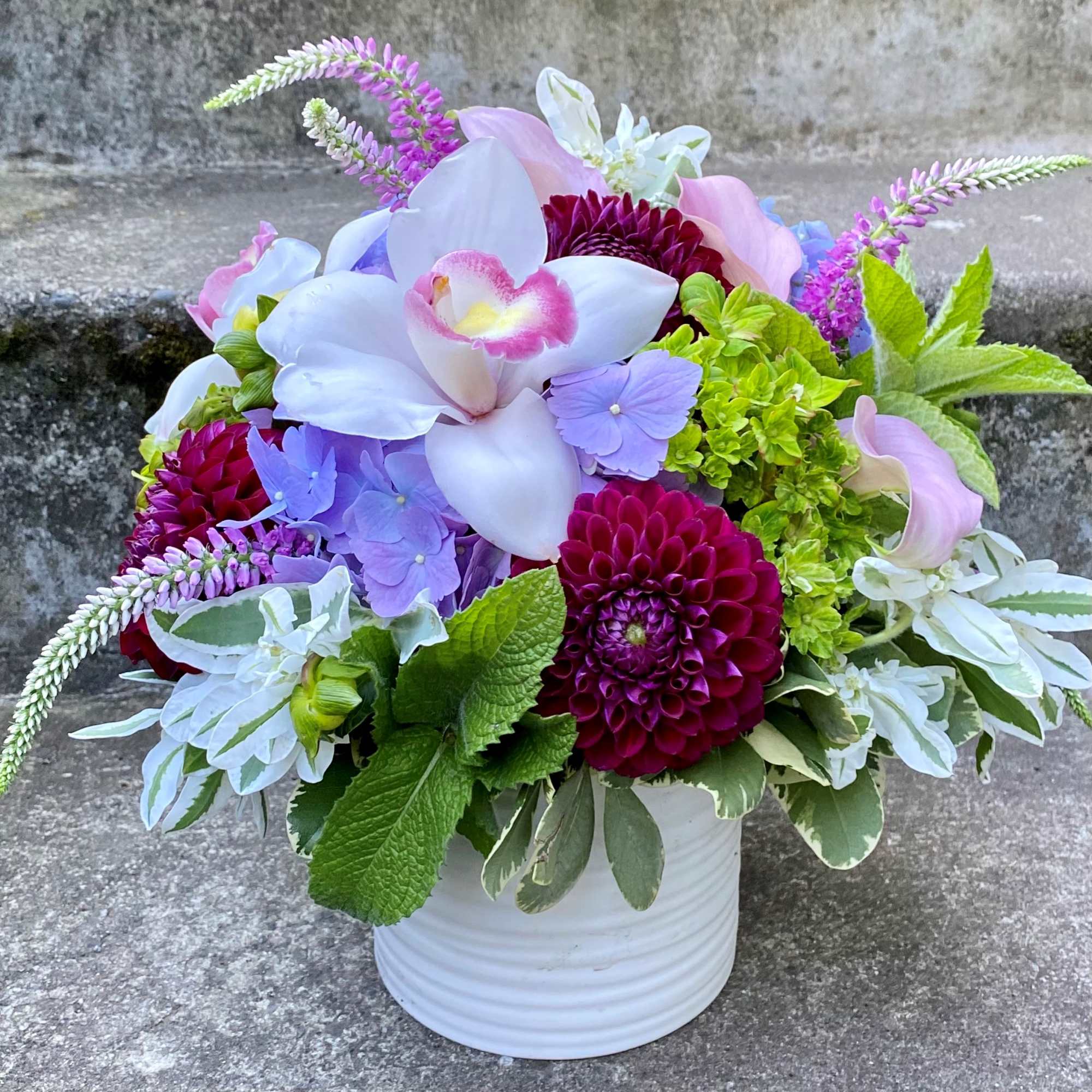 A Designer's Choice mixed floral arrangement featuring summer flowers such as dahlias