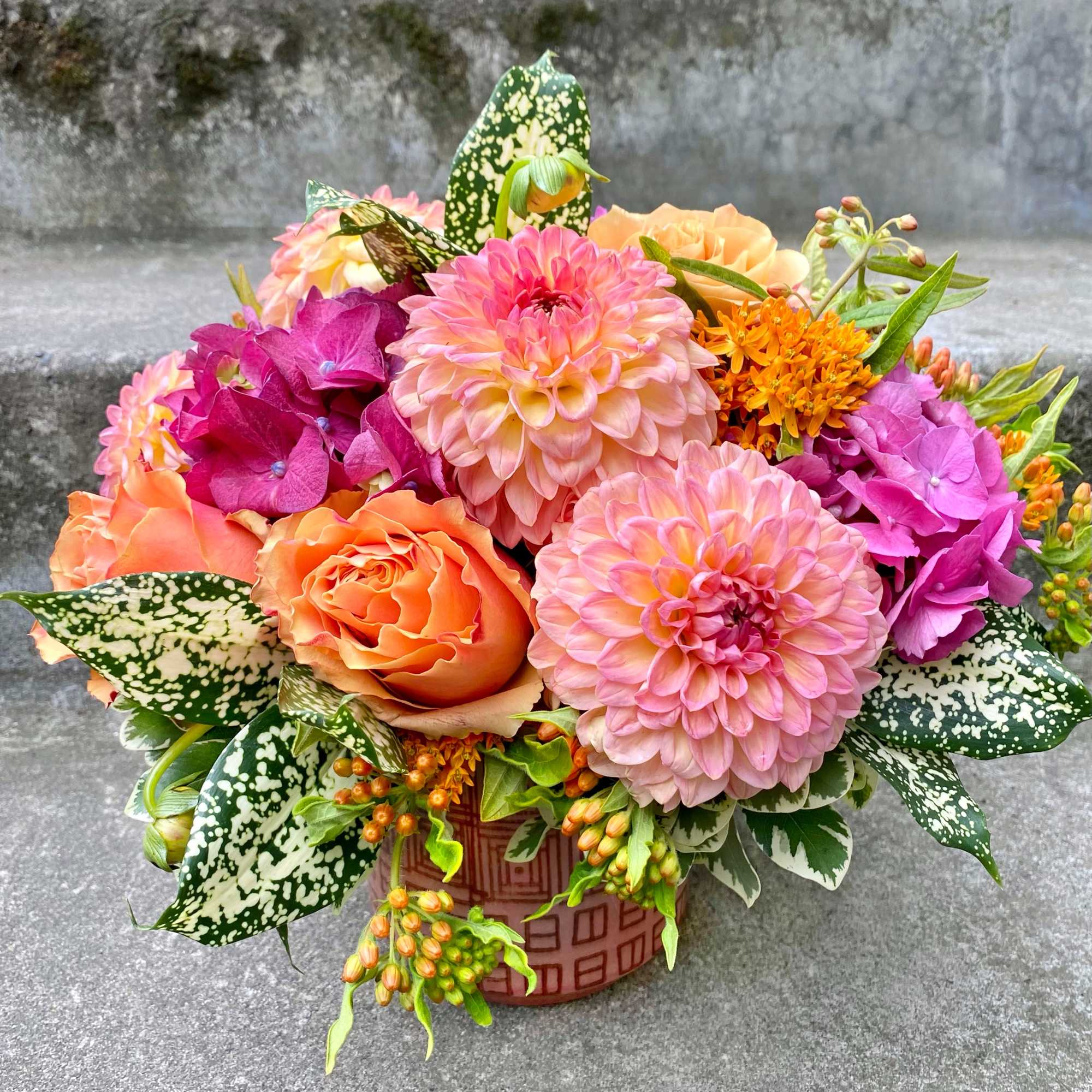 A Designer's Choice mixed floral arrangement featuring summer flowers such as dahlias