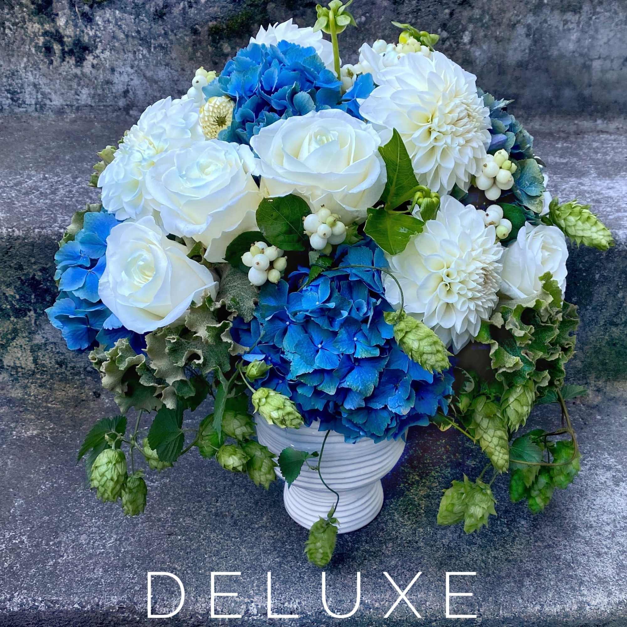 A Designer's Choice mixed floral arrangement featuring summer flowers such as dahlias