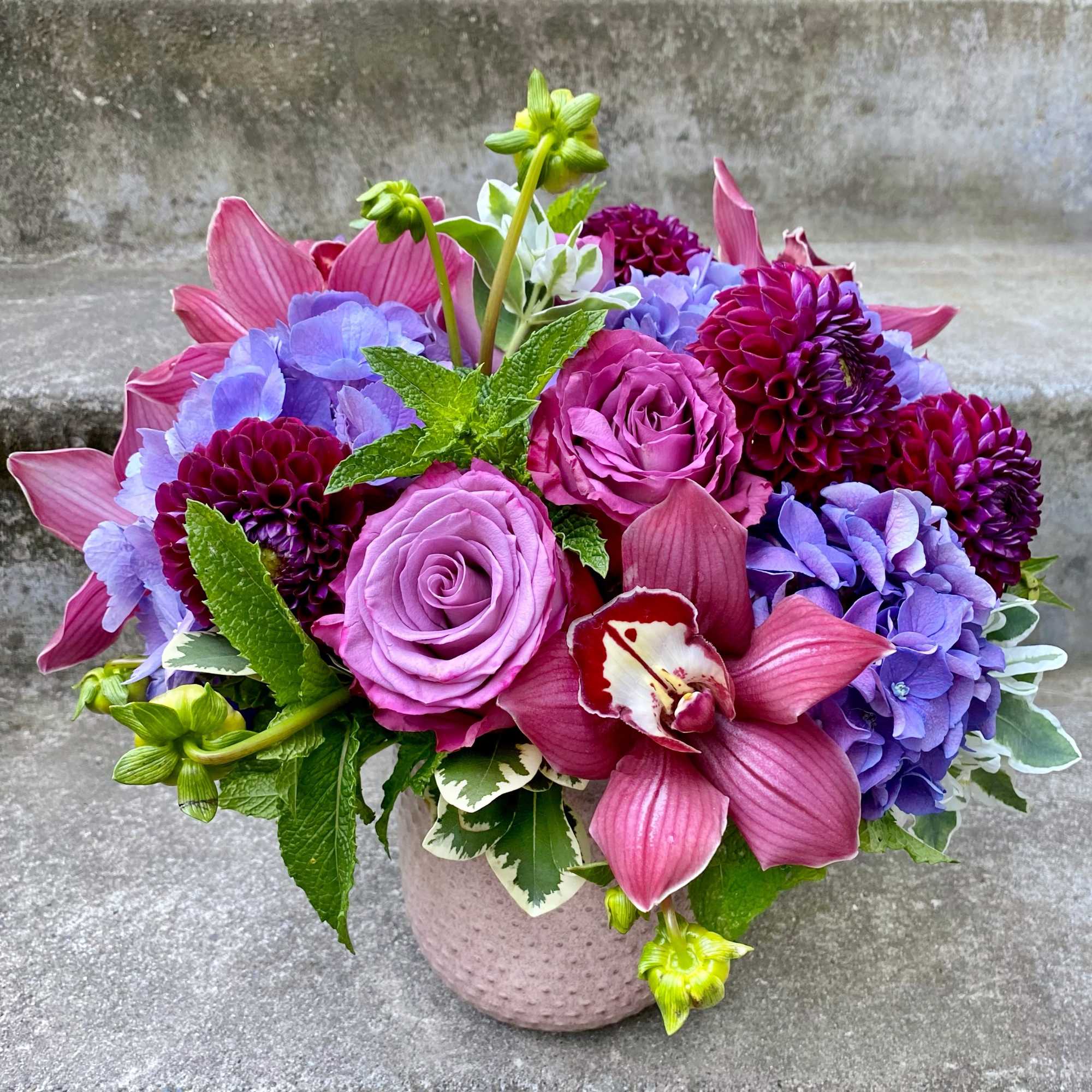 A Designer's Choice mixed floral arrangement featuring summer flowers such as dahlias