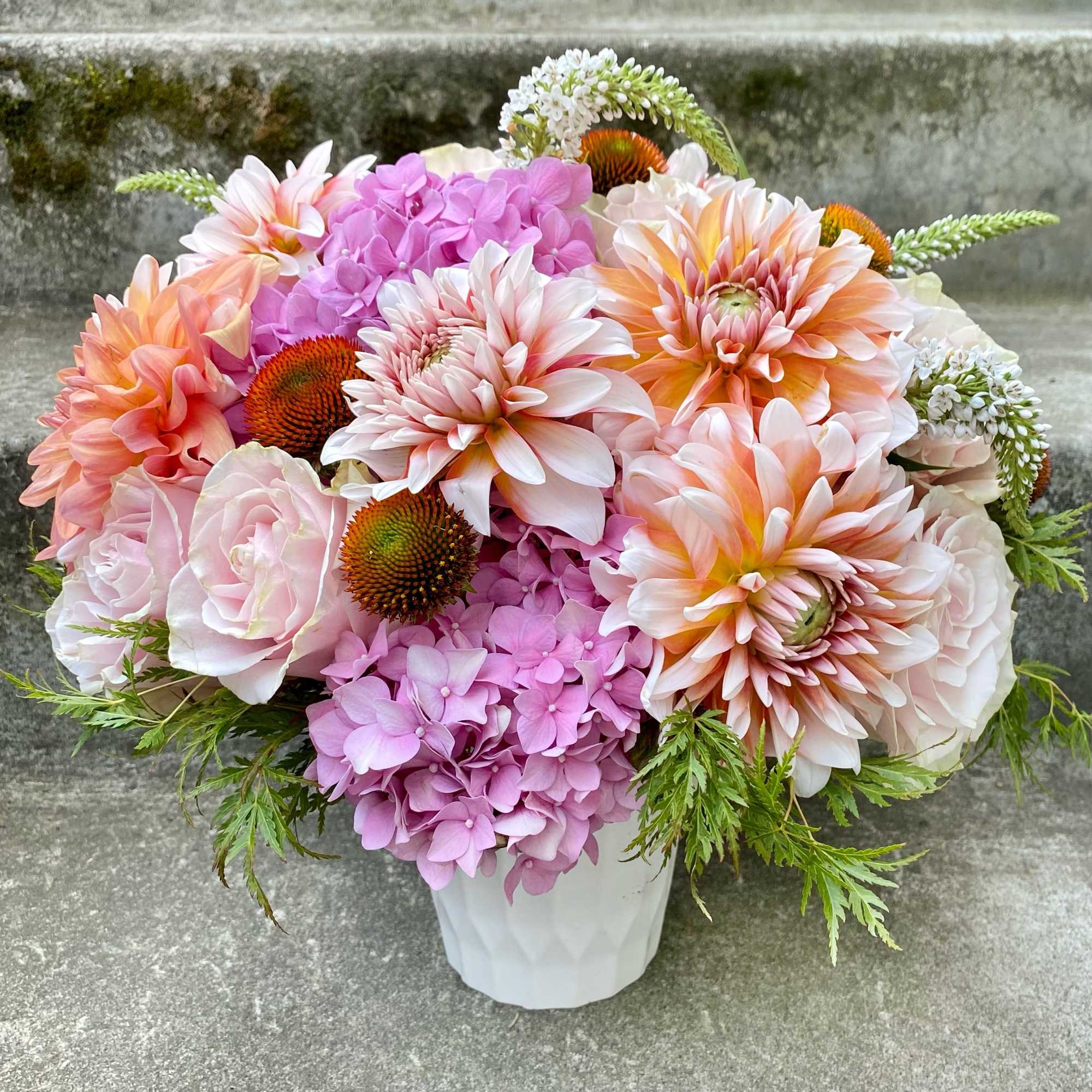 A Designer's Choice mixed floral arrangement featuring summer flowers such as dahlias
