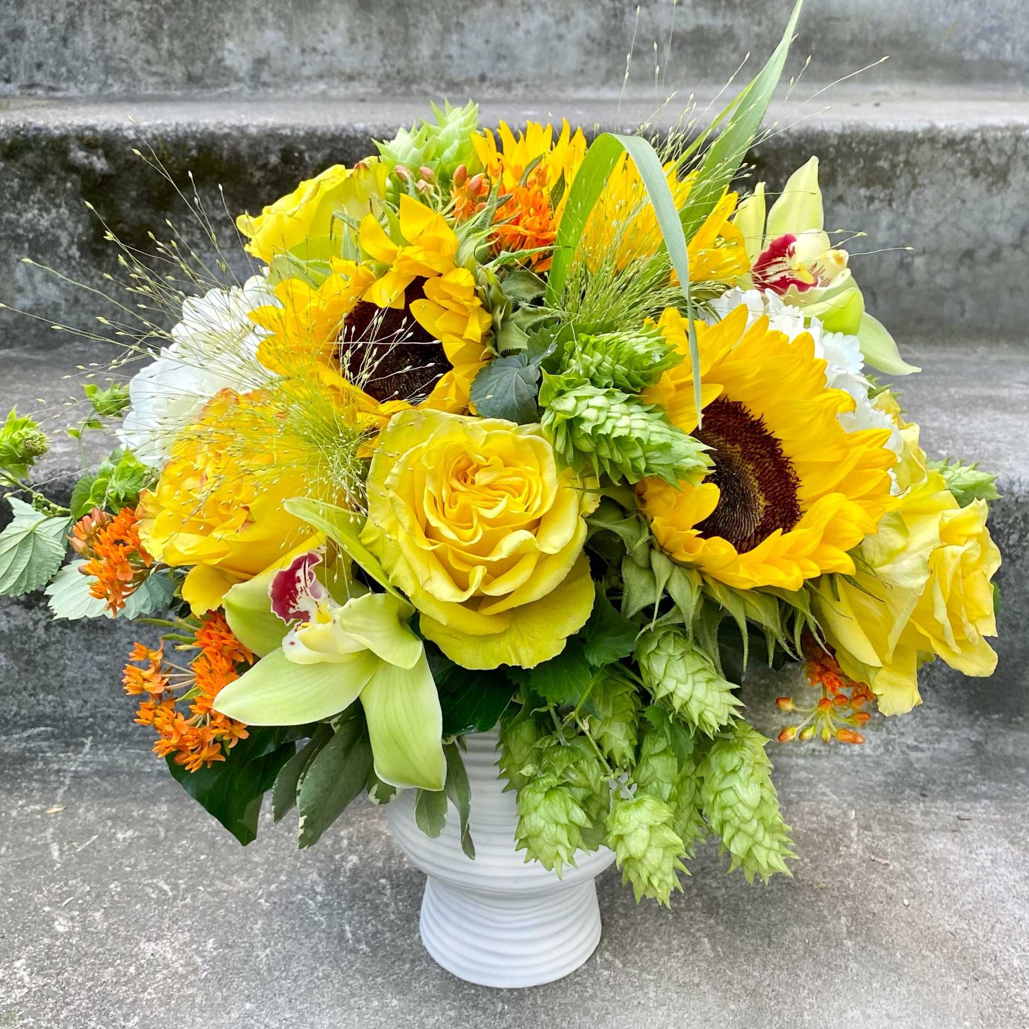A Designer's Choice mixed floral arrangement featuring summer flowers such as dahlias