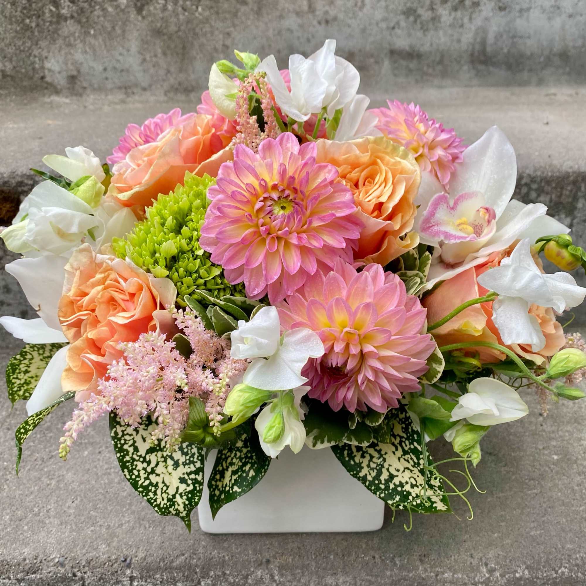 A Designer's Choice mixed floral arrangement featuring summer flowers such as dahlias