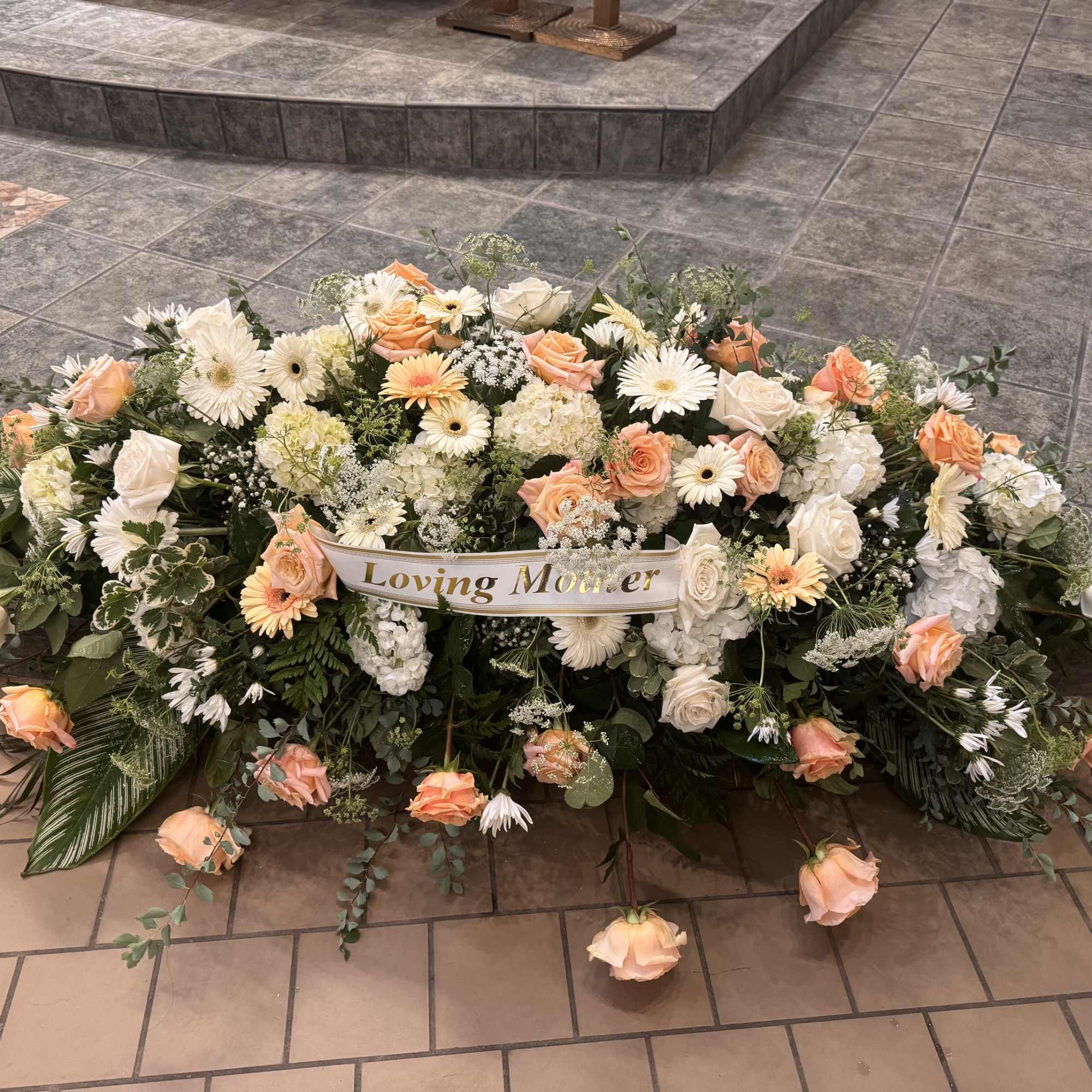 Peach and white flowers to be placed above the casket of your