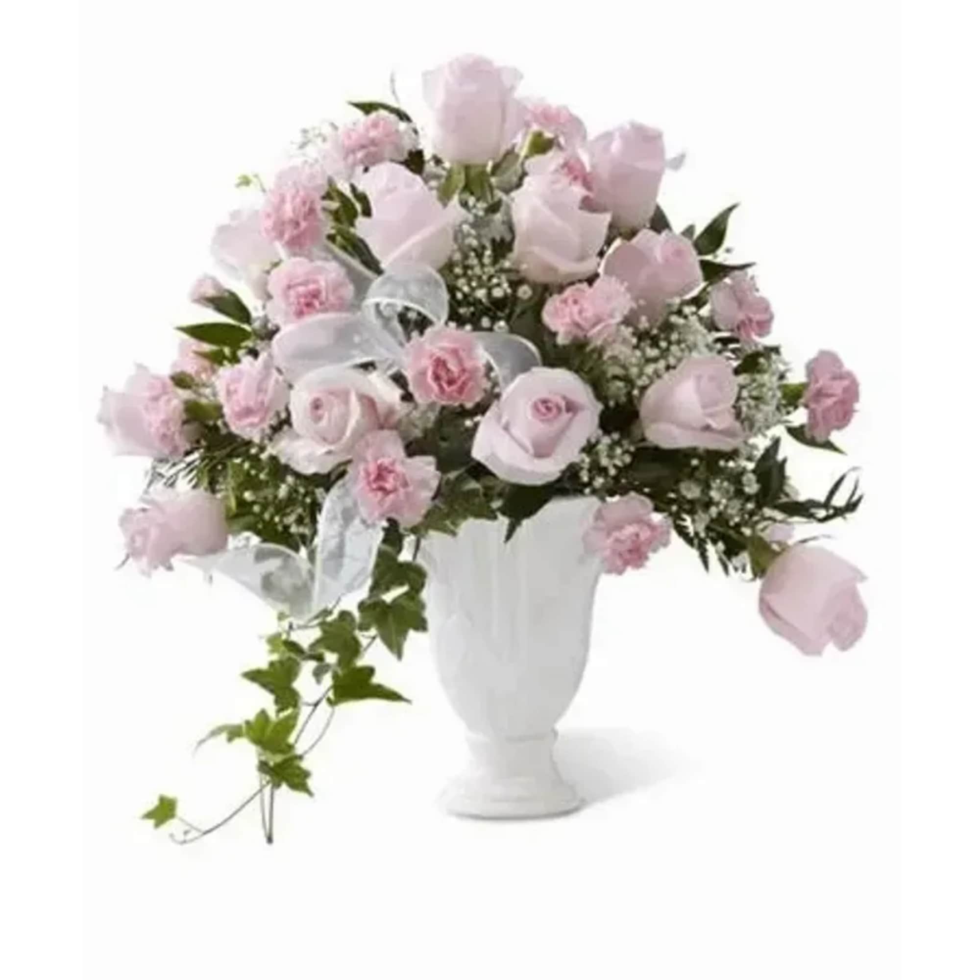 Pale pink roses and pink carnations are offset by baby's breath, variegated