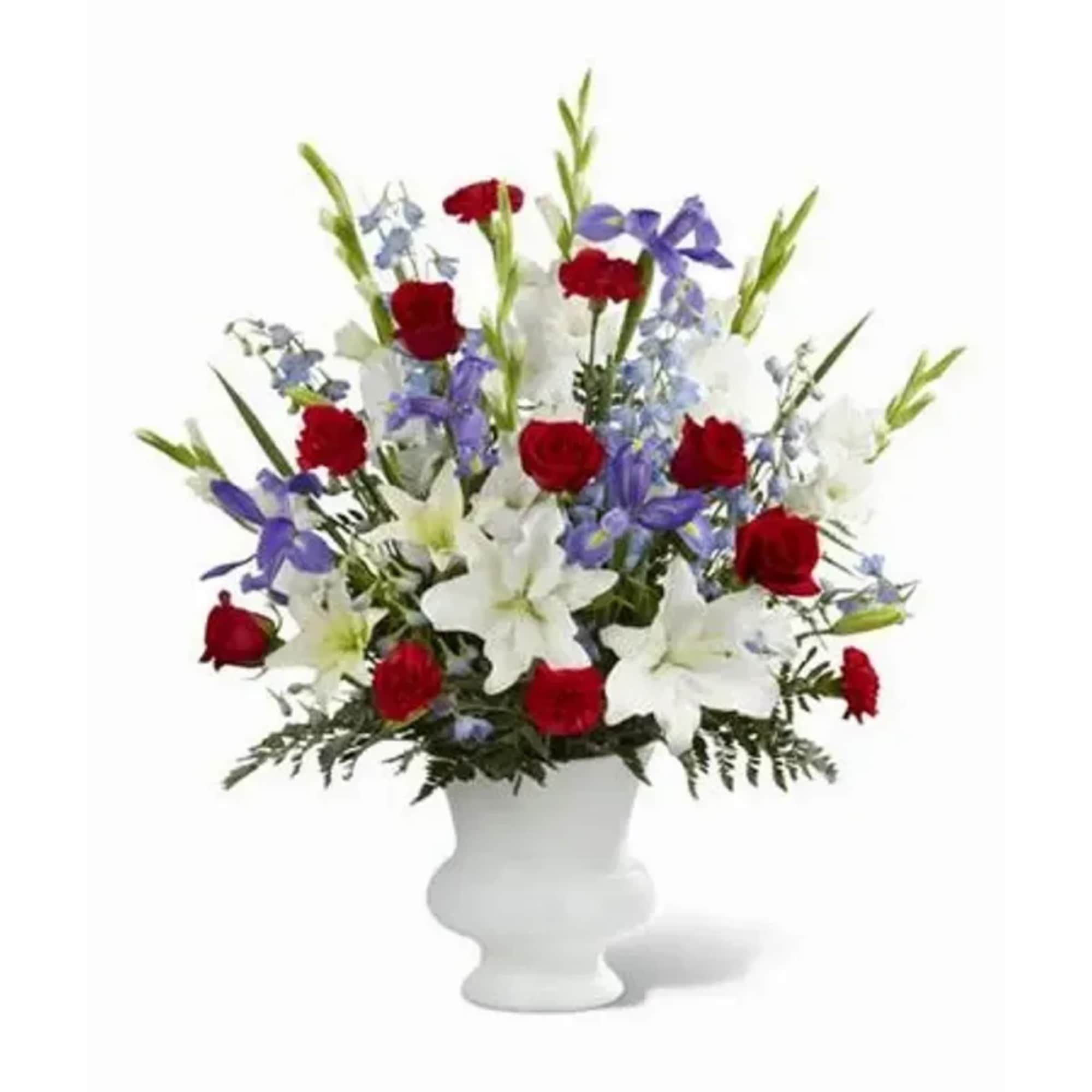 Red roses, red carnations, white gladiolus, light blue delphinium, blue iris, white