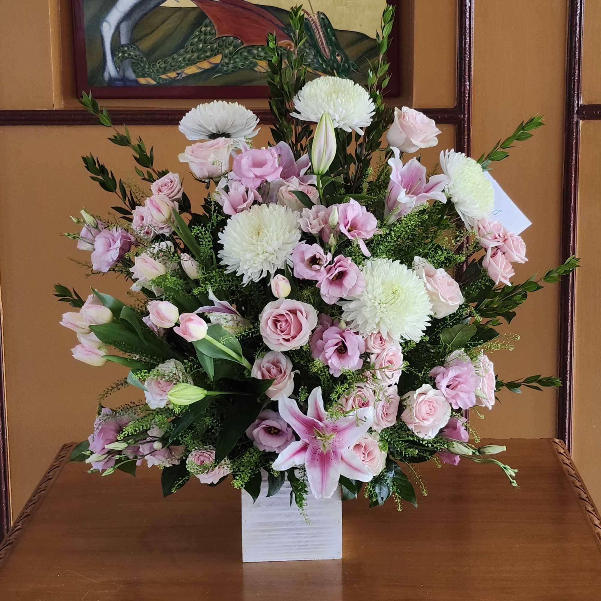 This pink and white funeral basket is a lovely sendoff and tribute.