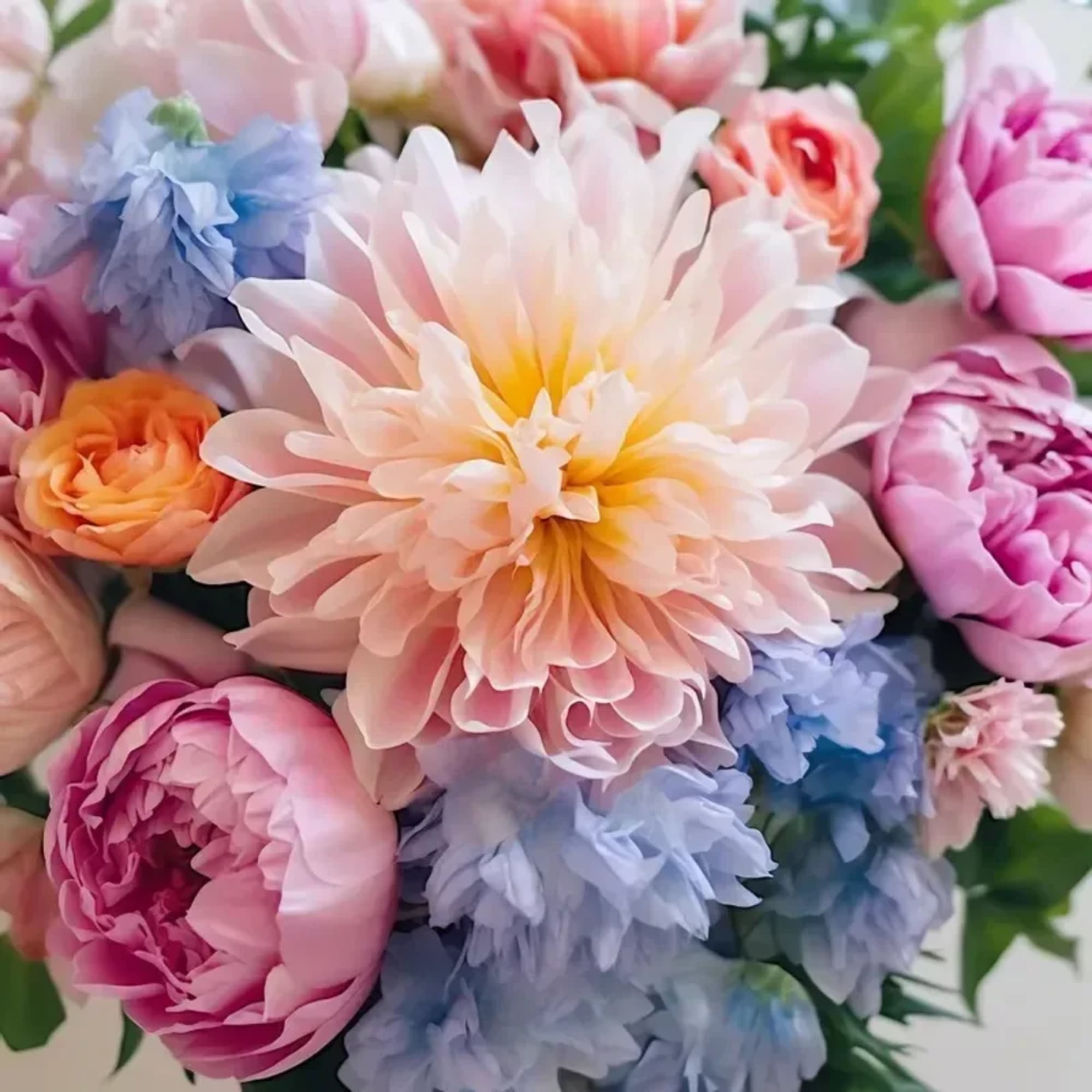 An arrangement of seasonal blooms for Spring arranged no vase. PLEASE NOTE:
