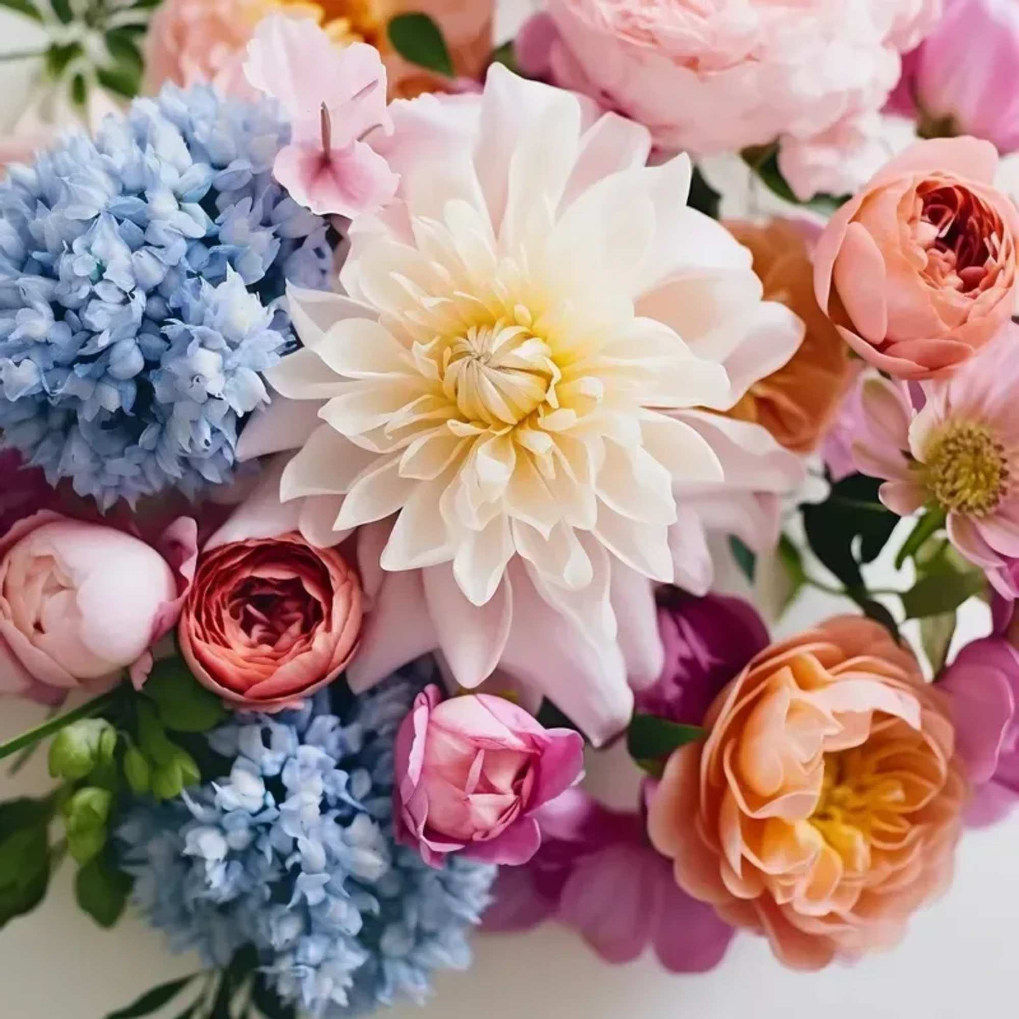 A bouquet  of seasonal blooms arranged no vase. PLEASE NOTE: Flower