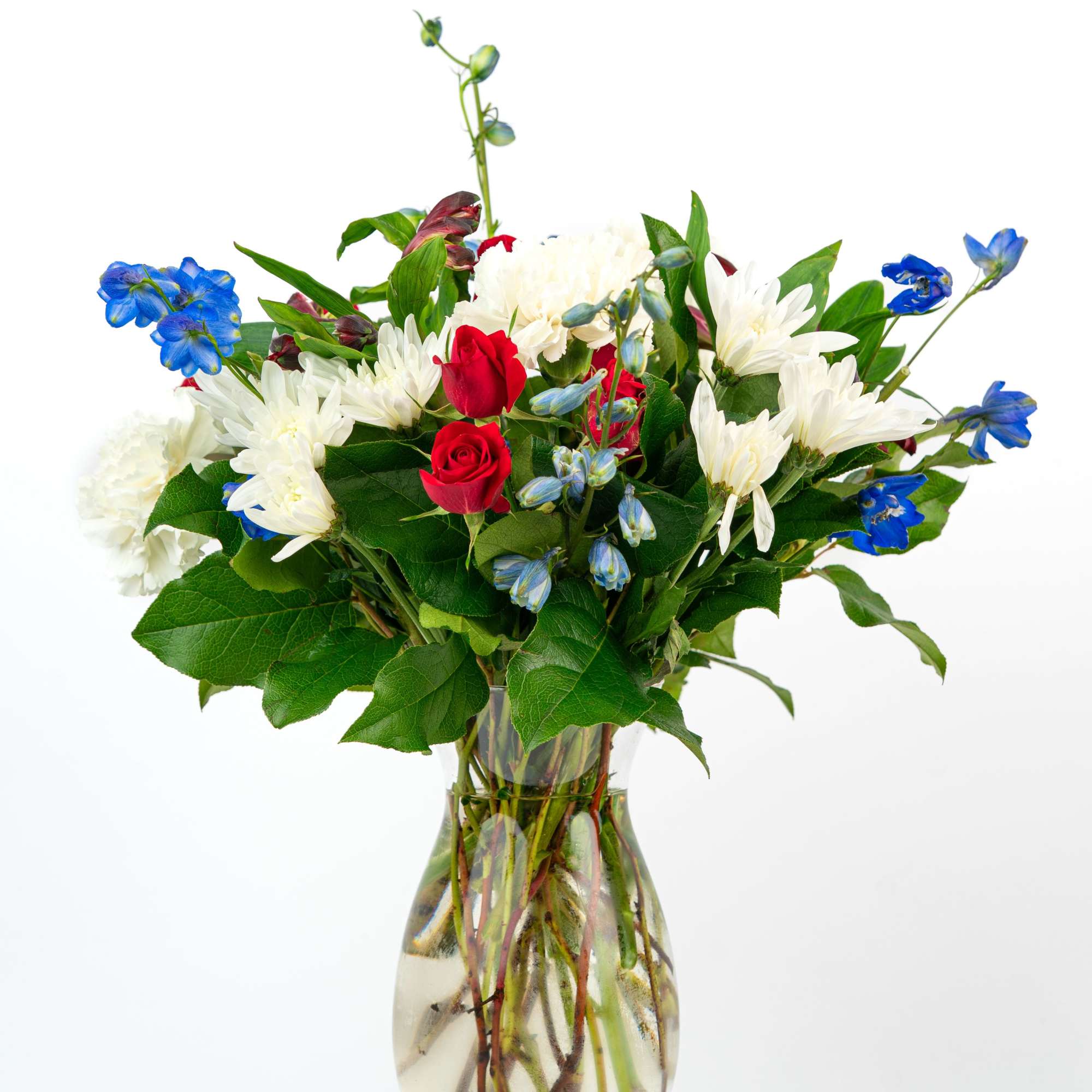 Red, white, and blue mixed flower arrangement in a clear glass vase