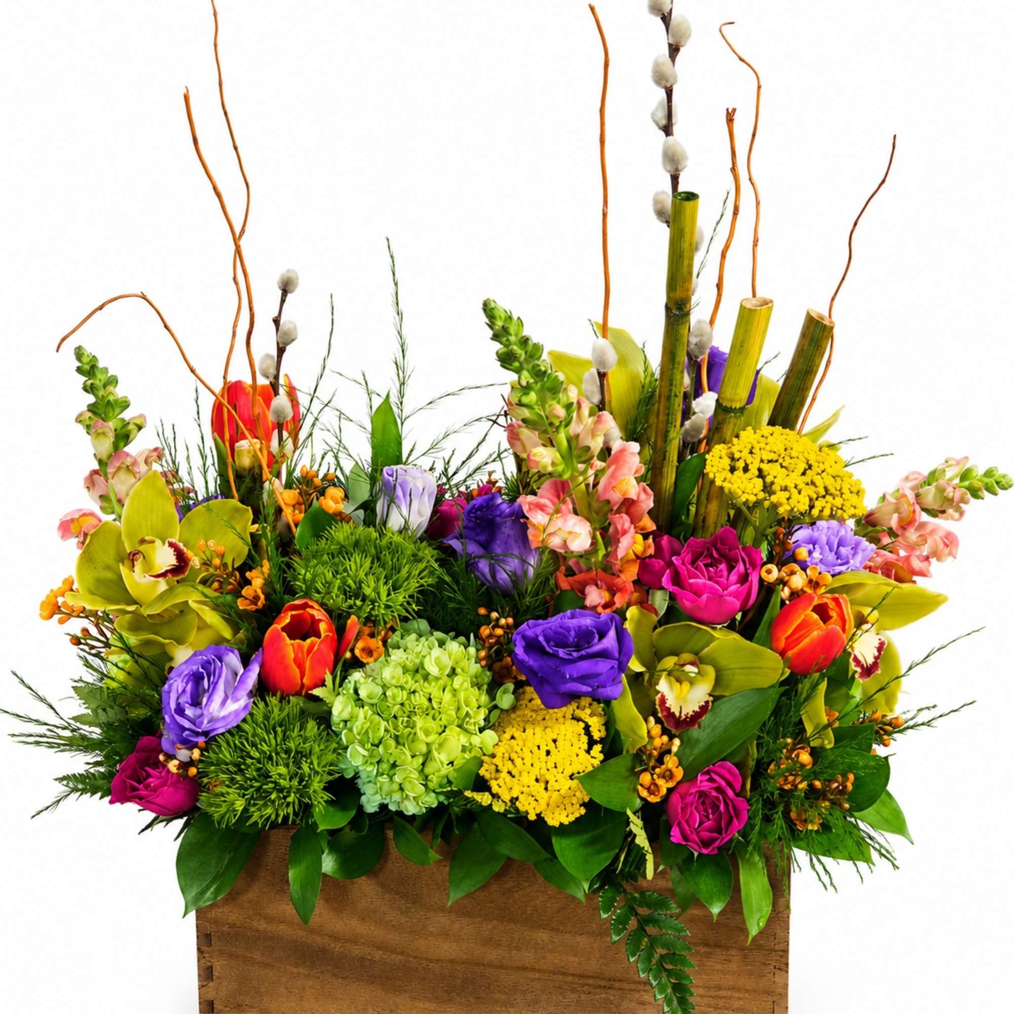 Colorful mixed flower arrangement in a wooden box with tall branches