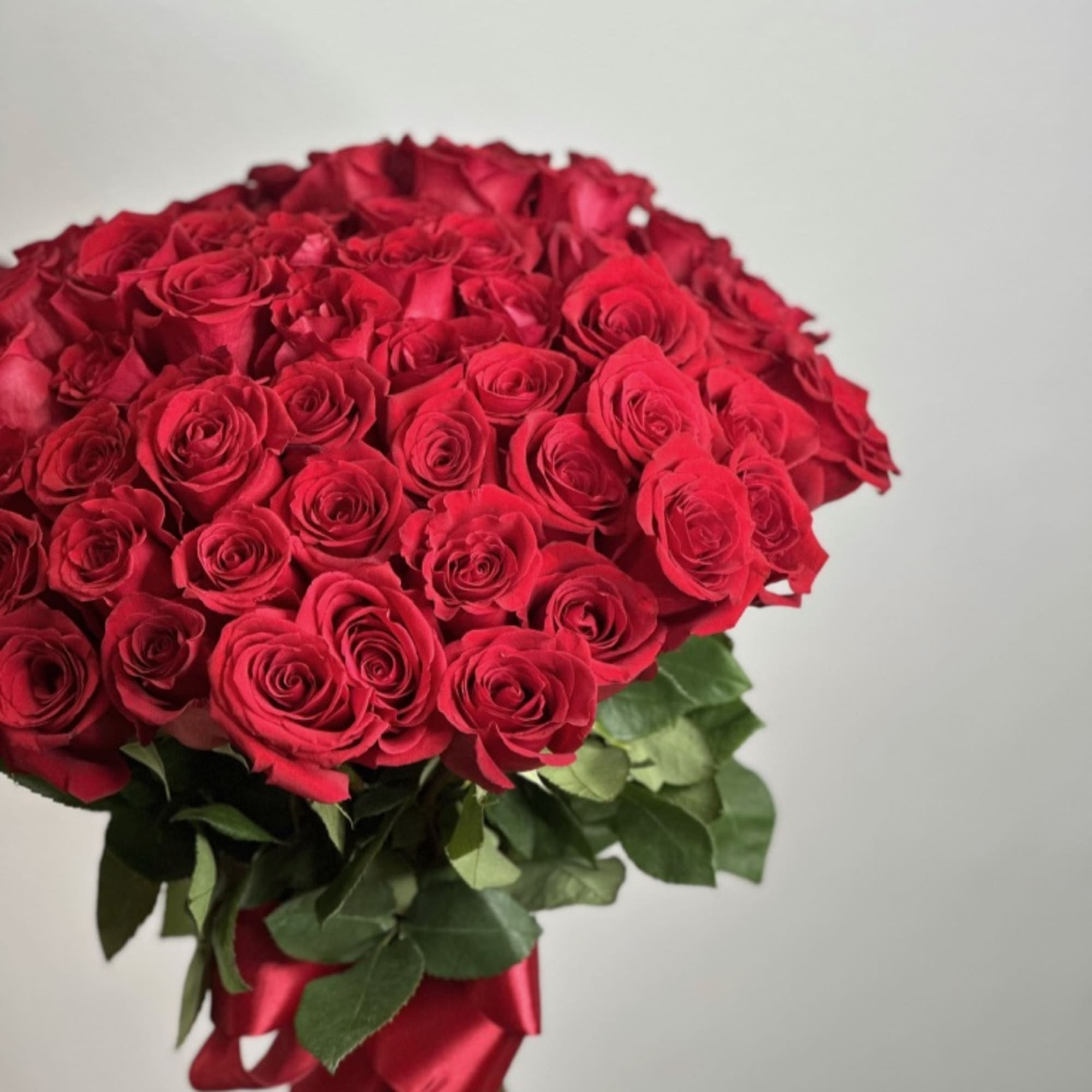 Large bouquet of red roses tied with a red ribbon, photo 2 of 3