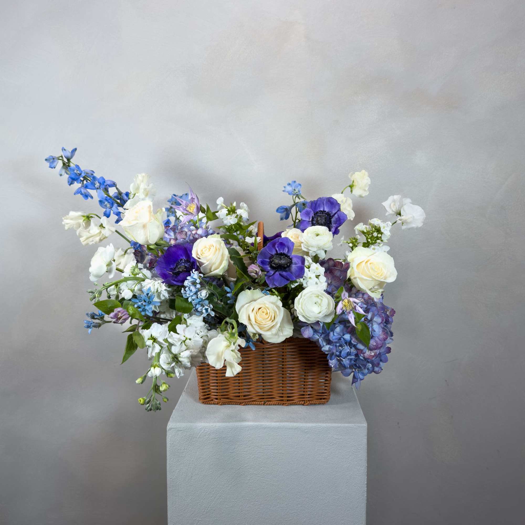 Raon (라온) - a naturally composed arrangement presented in a woven basket.Designed