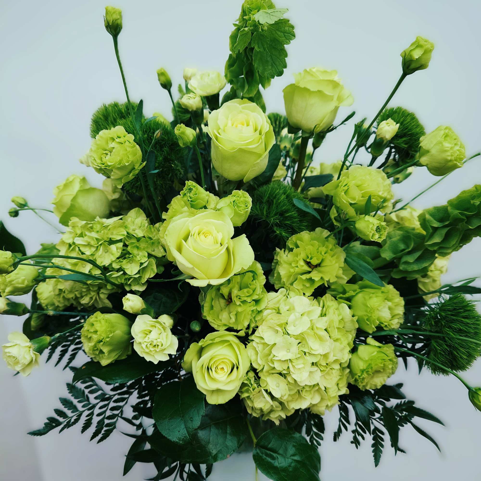 Lush, fresh, monochrome with premium blooms in shades of green.