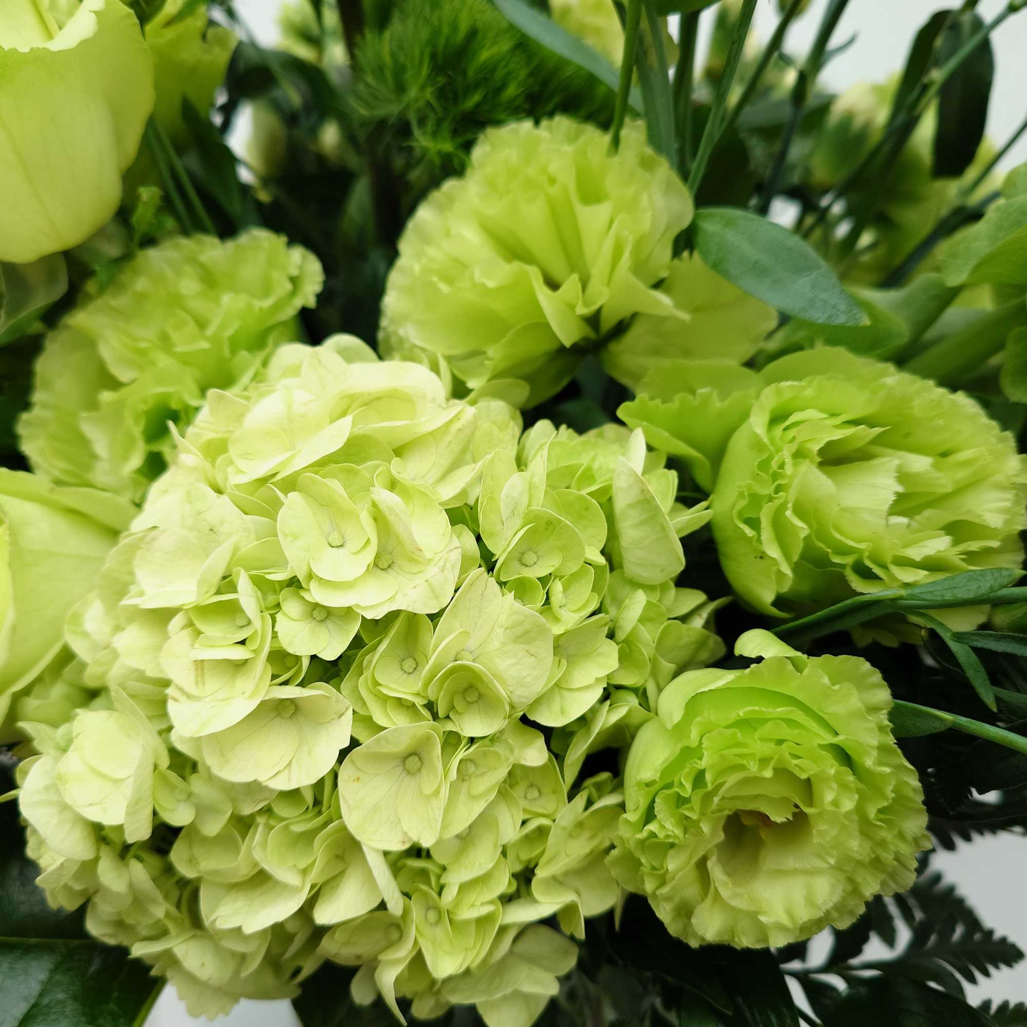 Lush, fresh, monochrome with premium blooms in shades of green.