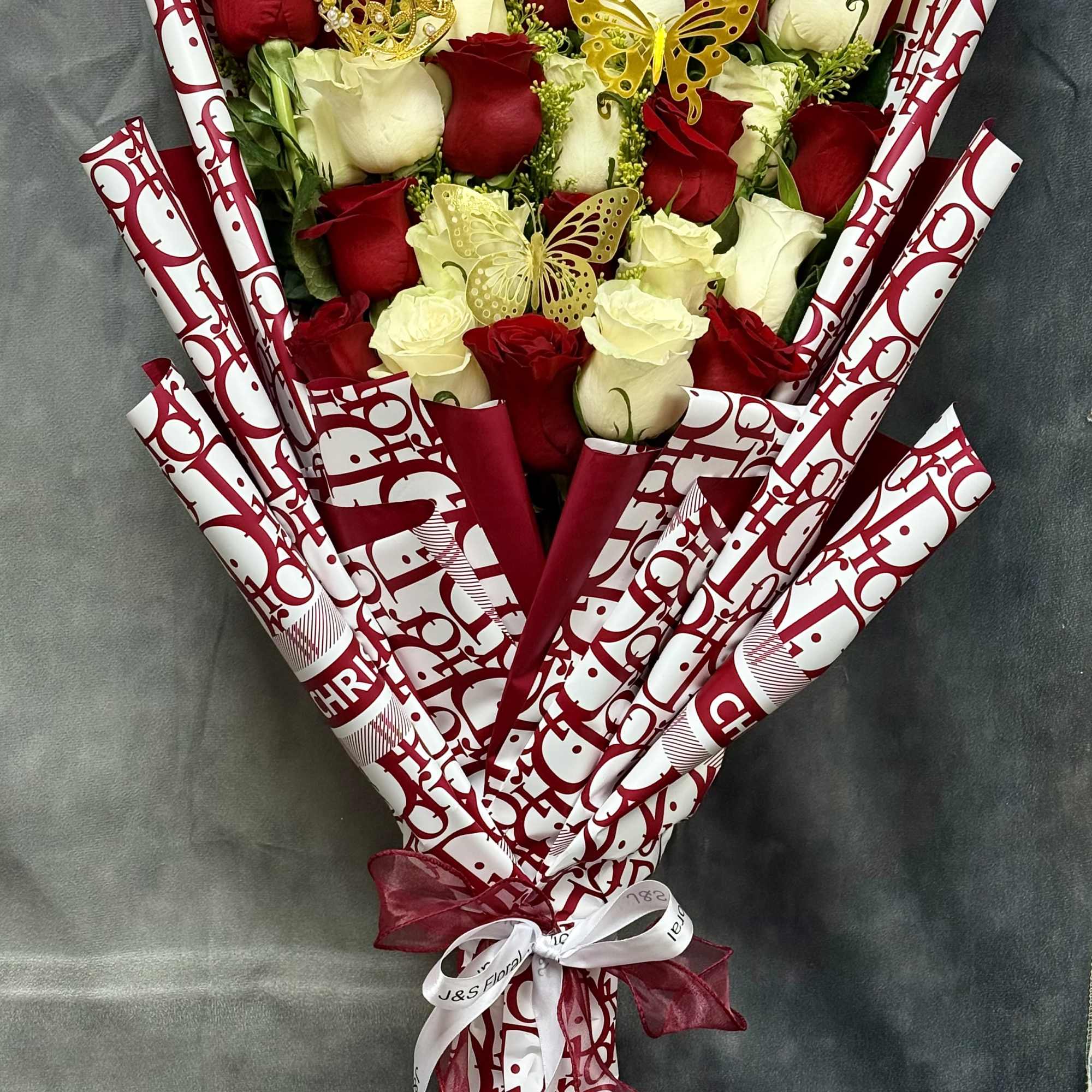 Two dozen radiant white &amp; red roses , elegantly layered and tied