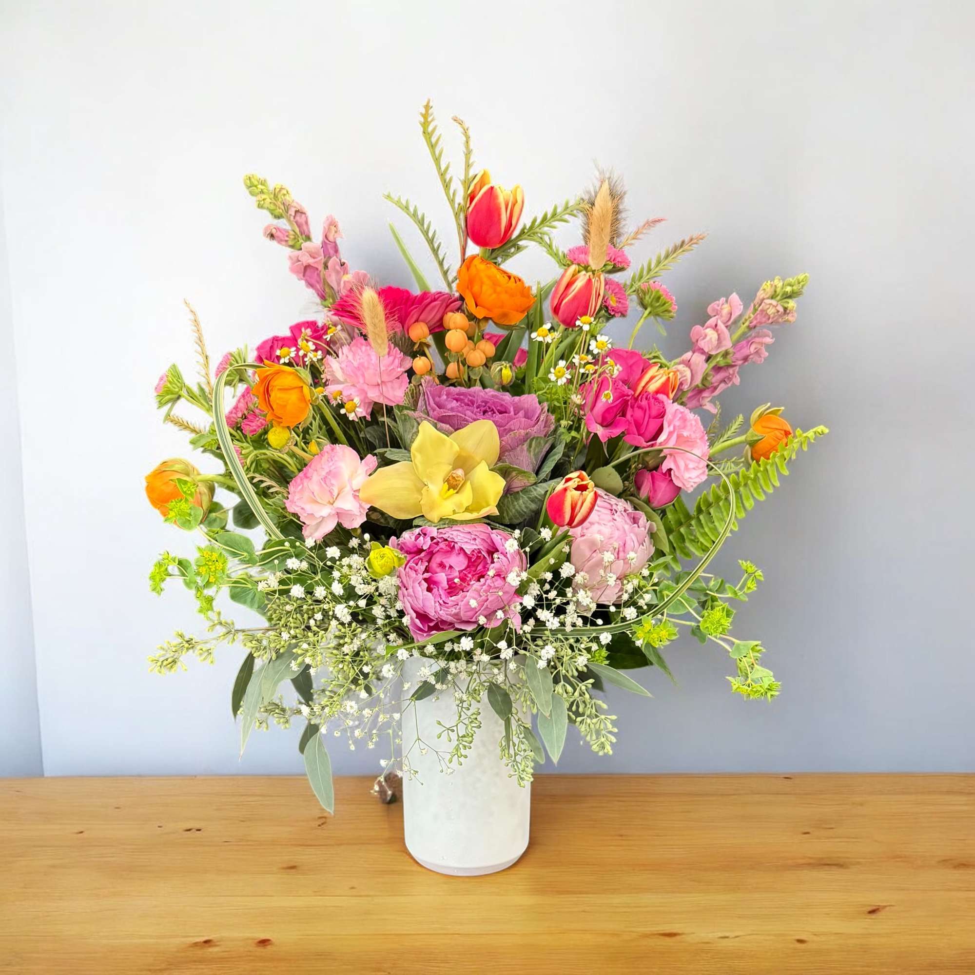 Colorful mixed bouquet in a white vase