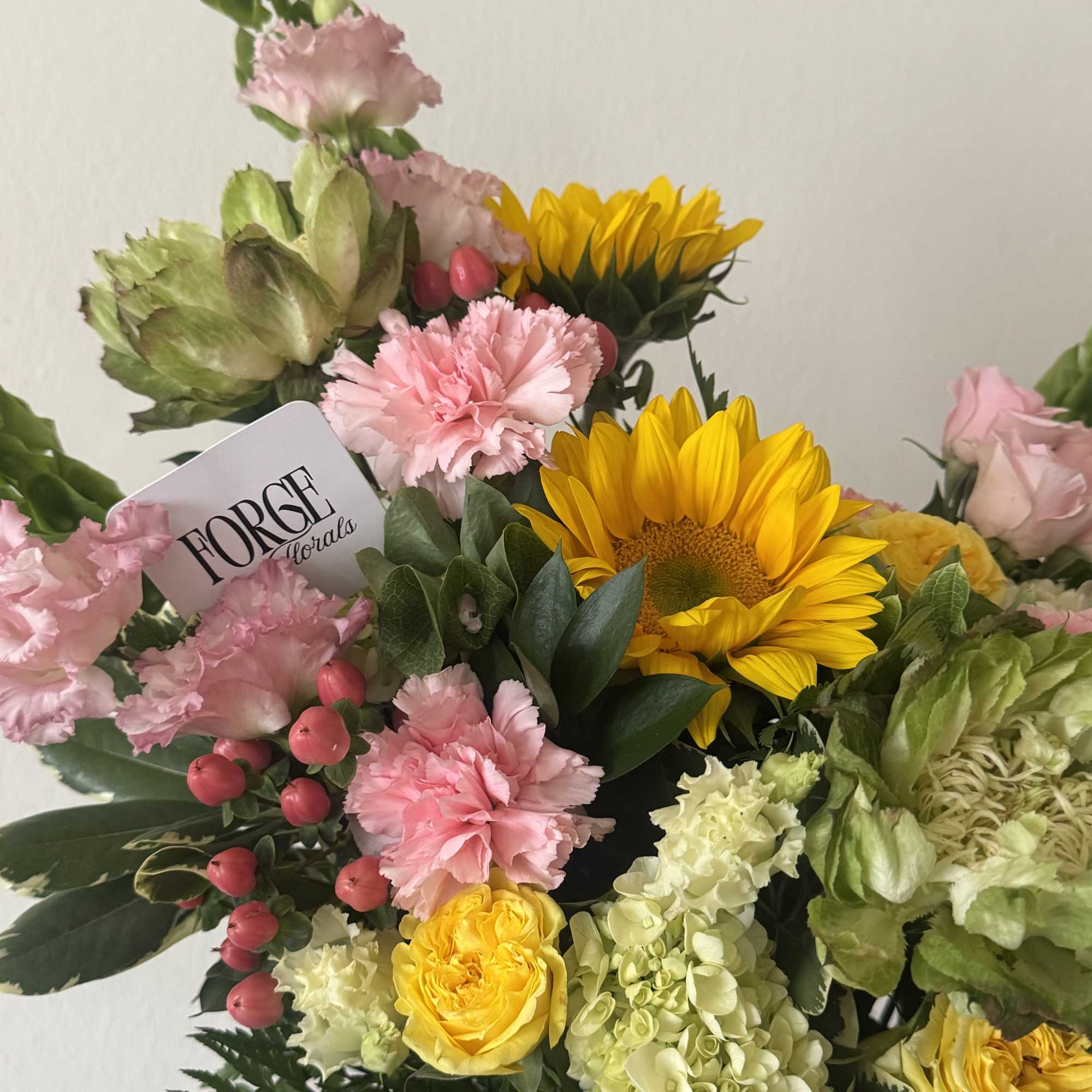  cheerful garden-style arrangement featuring premium seasonal blooms in soft pink, fresh