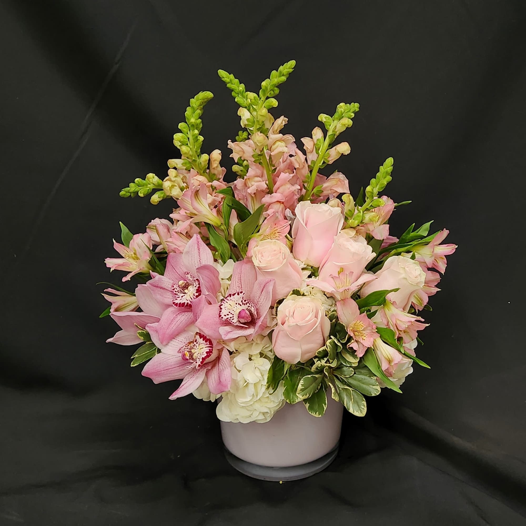 A Fabulous mix of Hydrangea, roses and cymbidium blooms.  Hand Designed