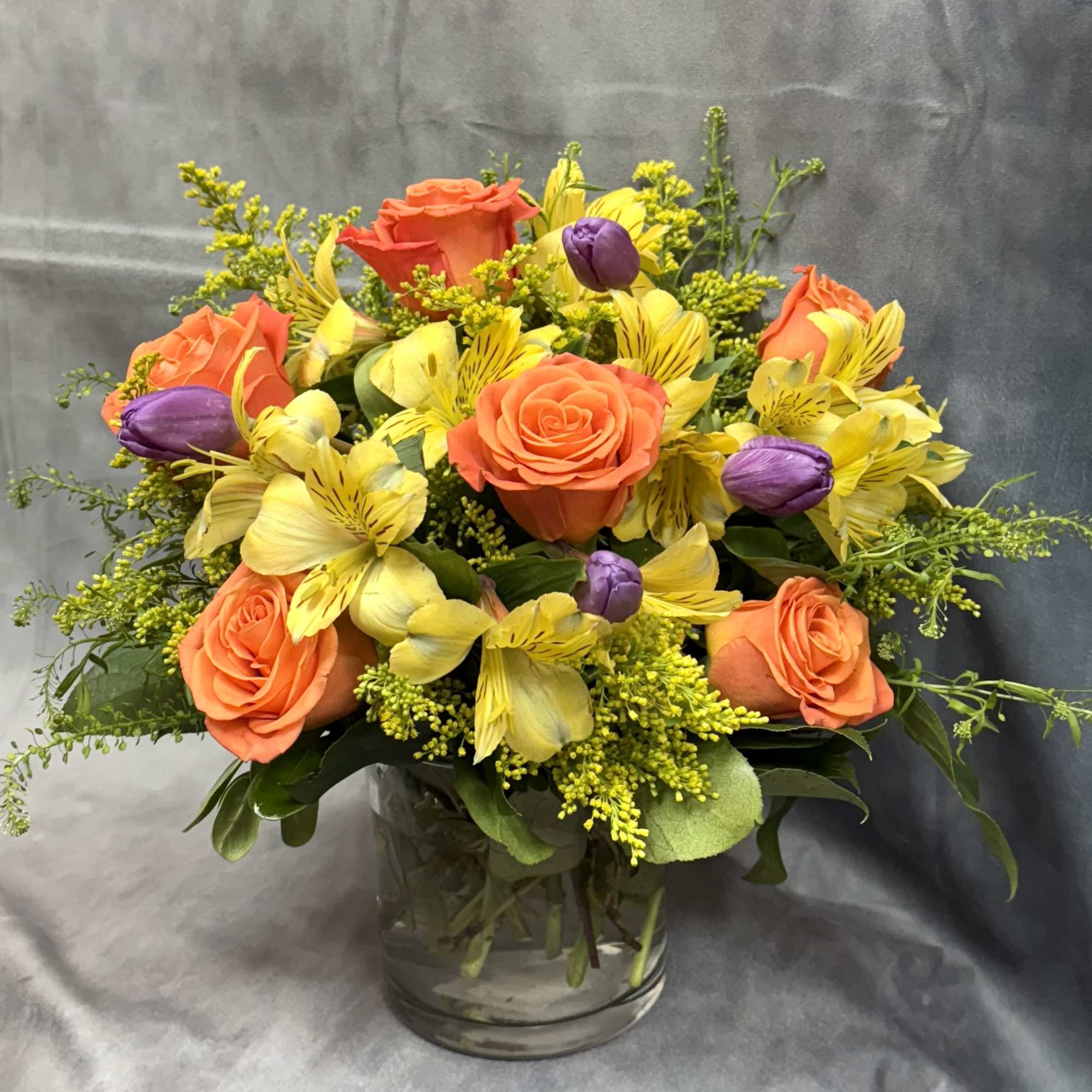A charming vase arrangement designed for rose and tulip lovers, featuring a