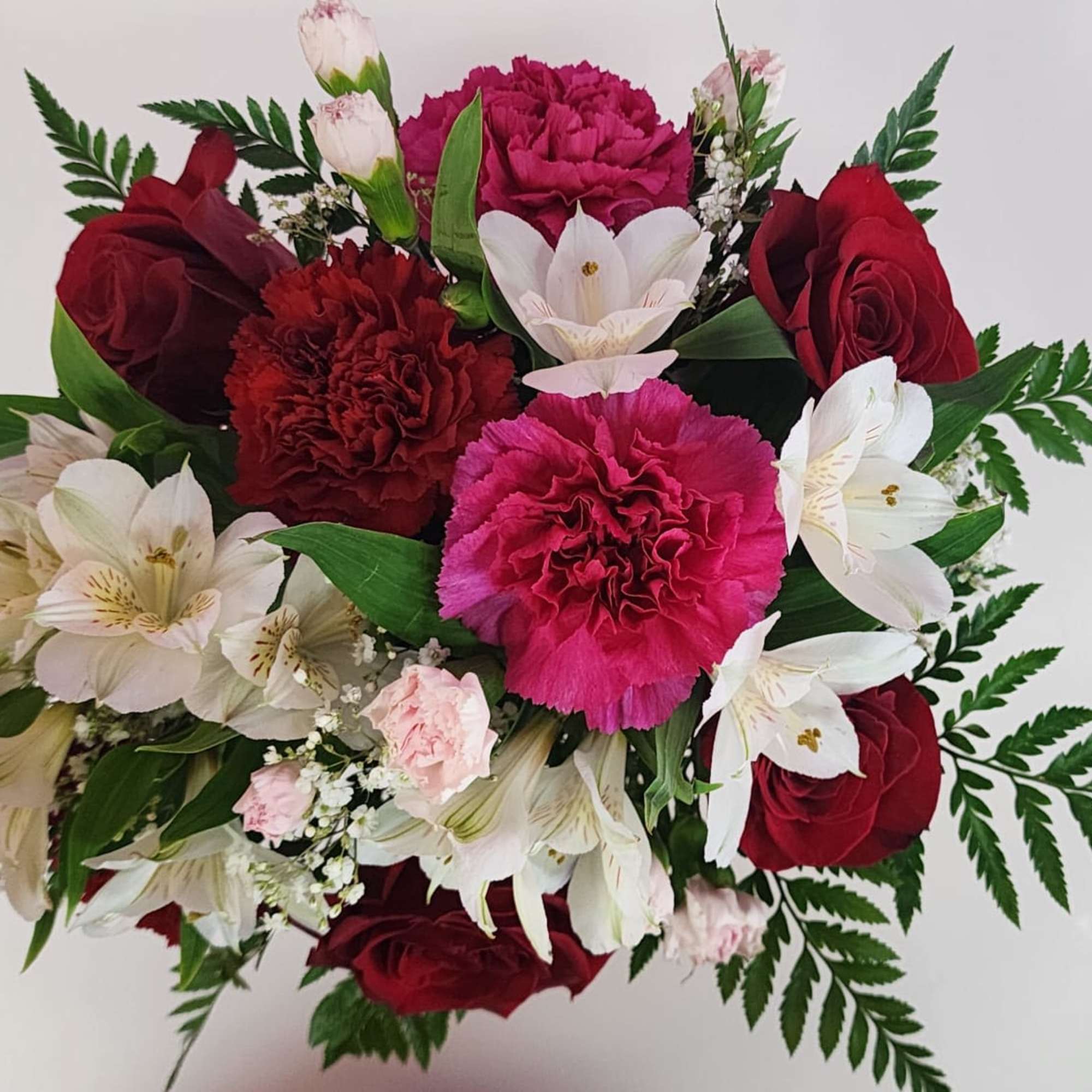 Bouquet of red roses, pink carnations, and white alstroemeria