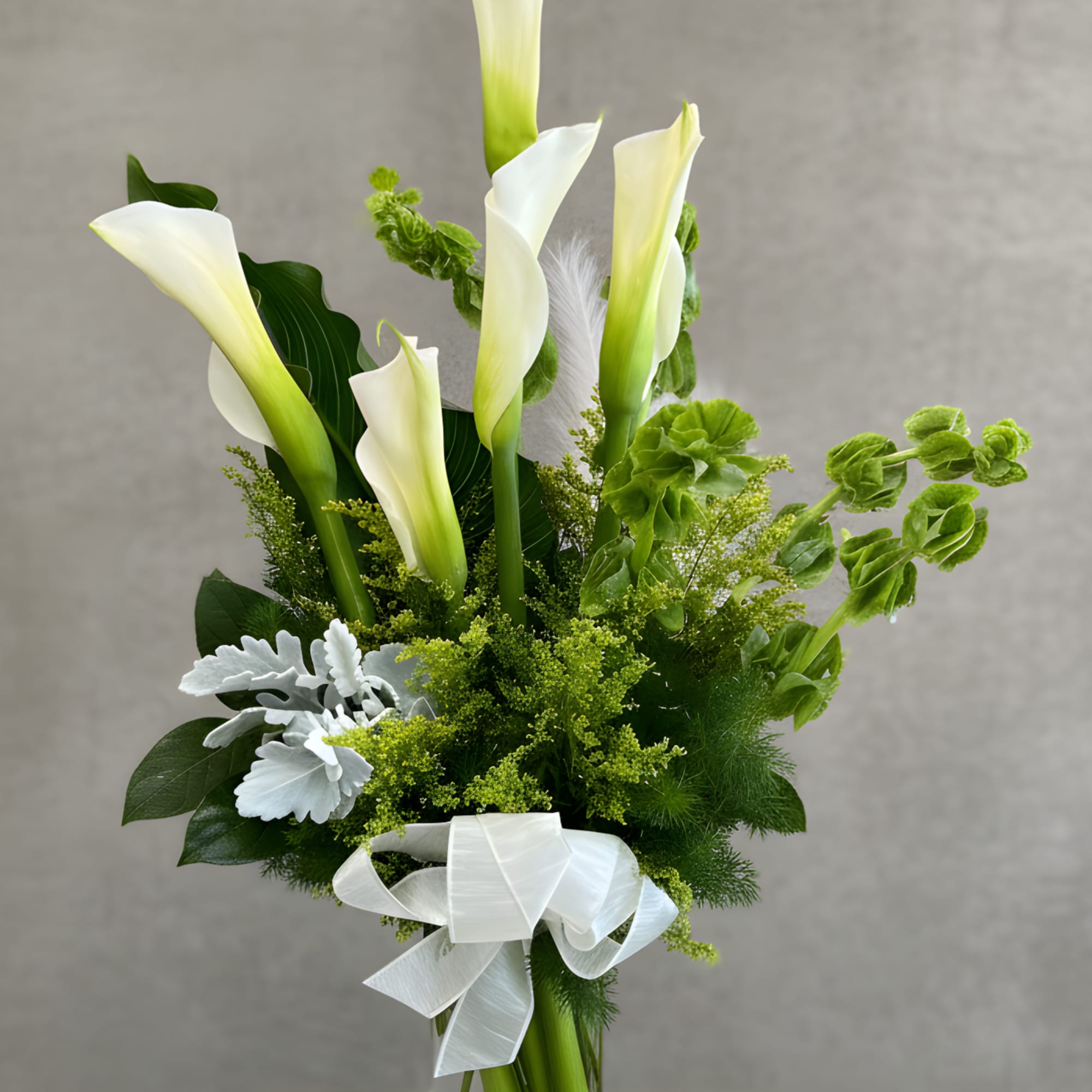 A stunning arrangement of fresh Calla Lilies, known for their sleek, trumpet-like