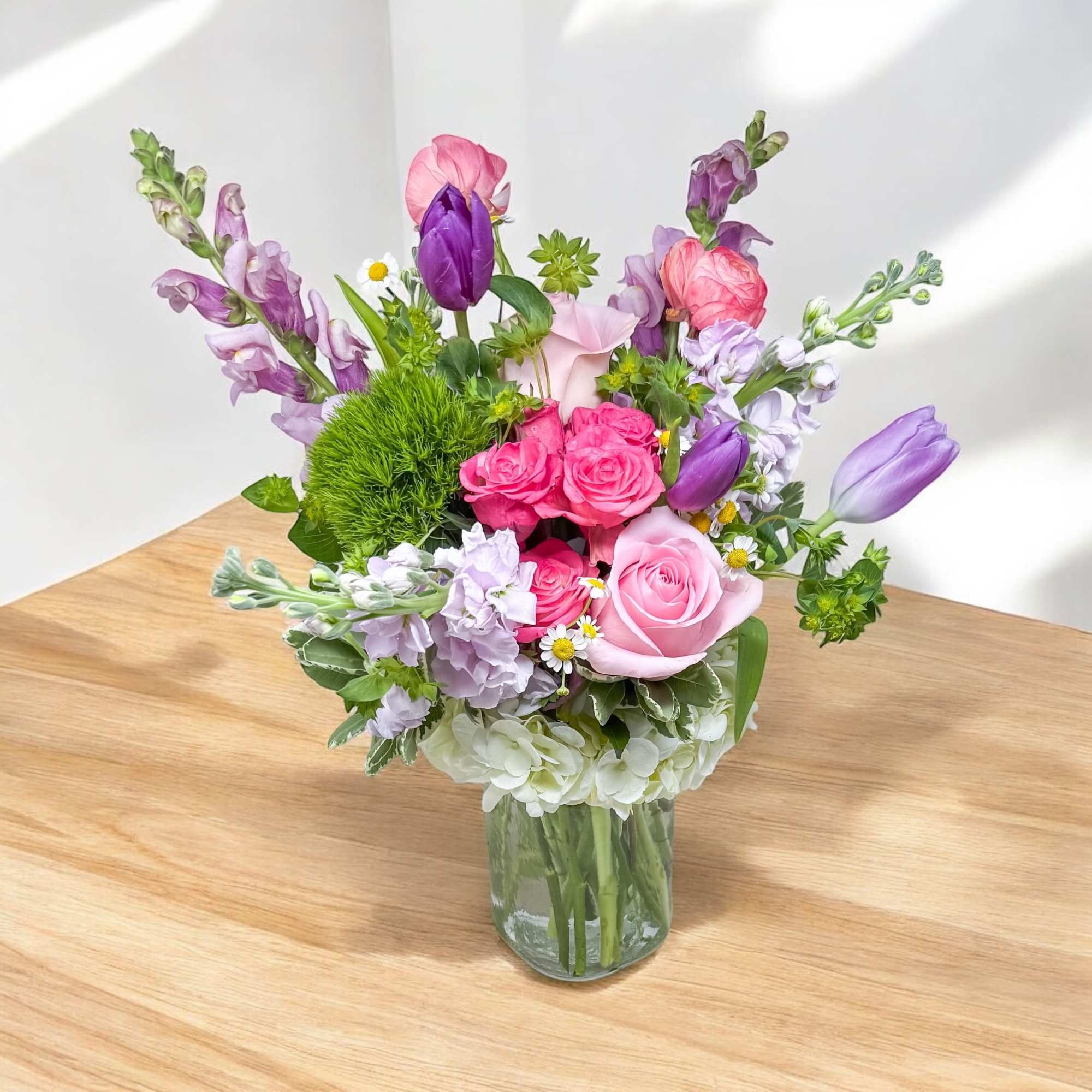 Mixed pink and purple bouquet in a clear glass vase, photo 2 of 2