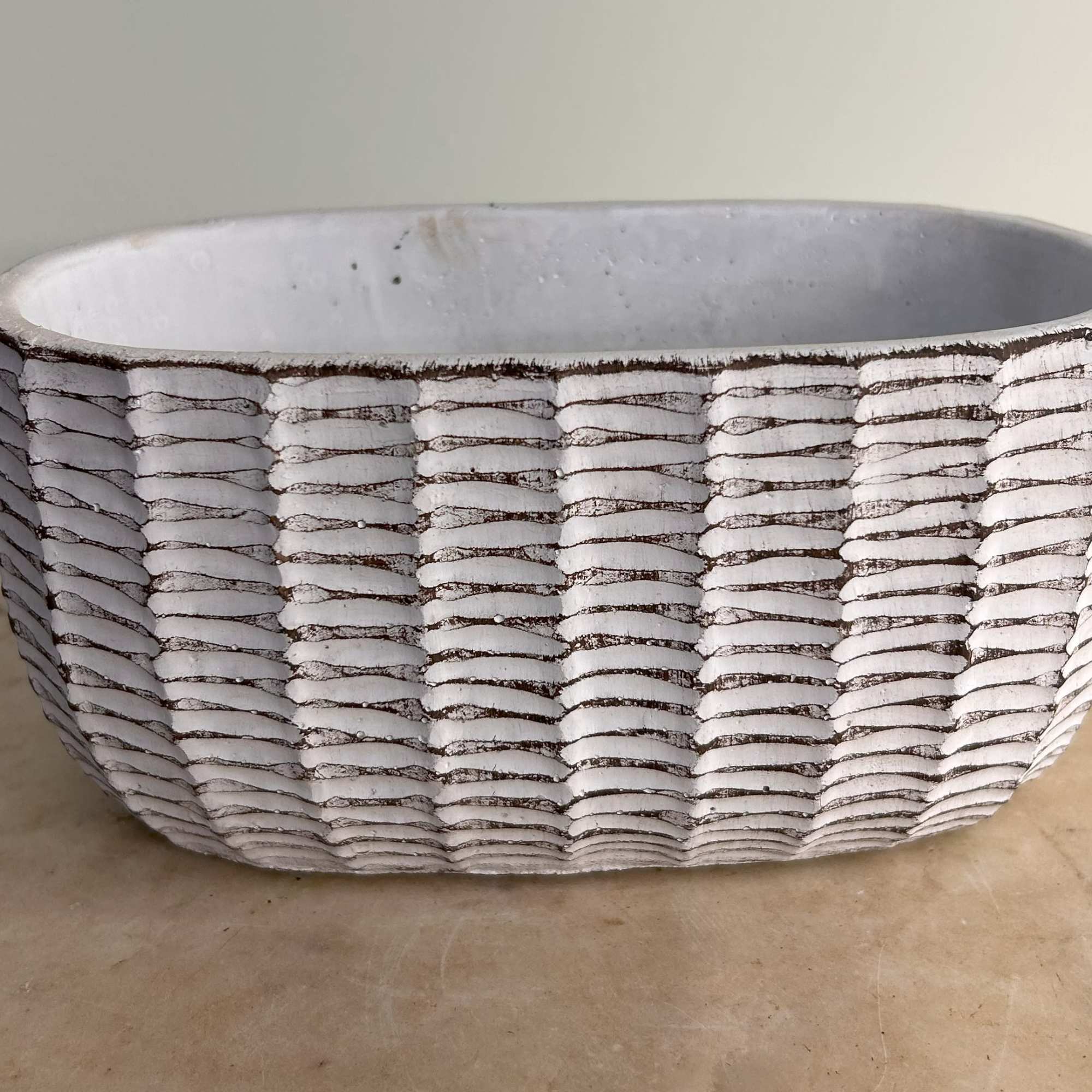 White textured ceramic planter with a ribbed pattern