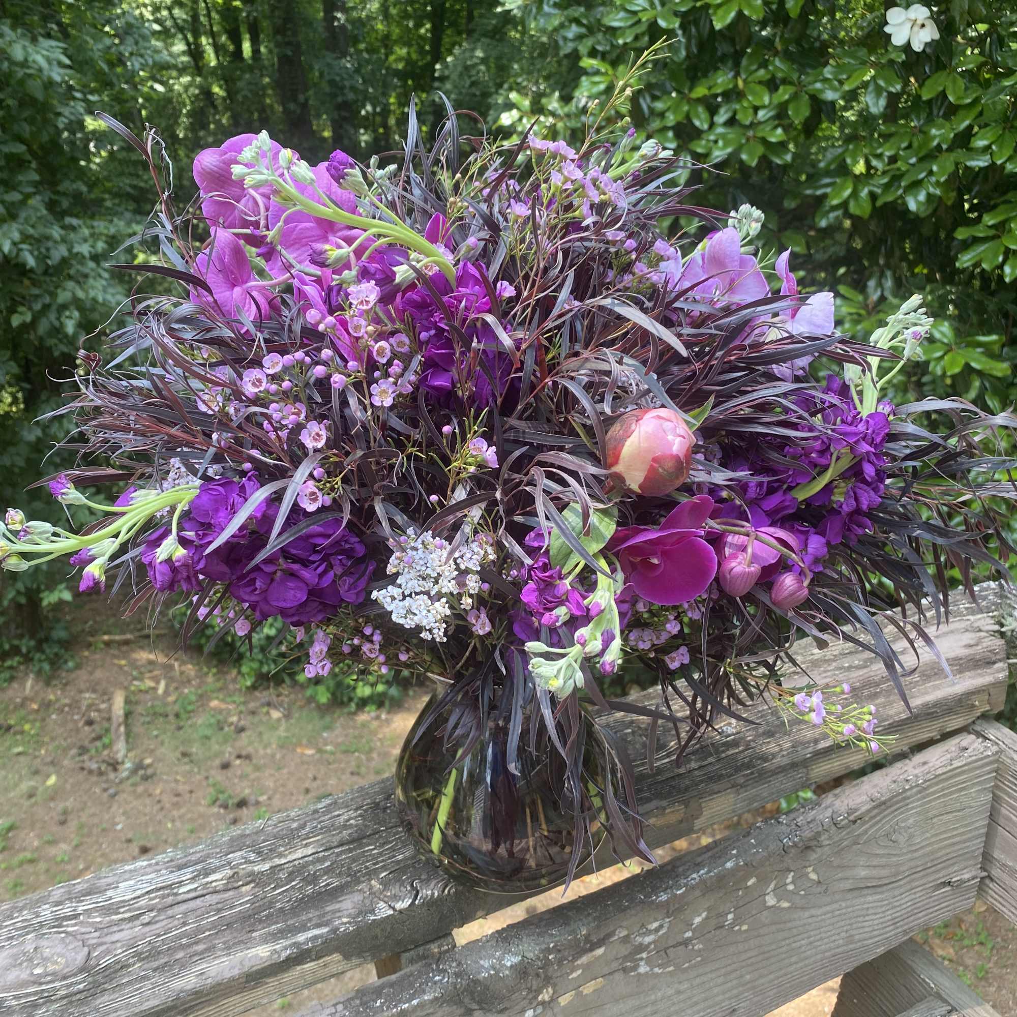 Purple floral bouquet in a glass vase