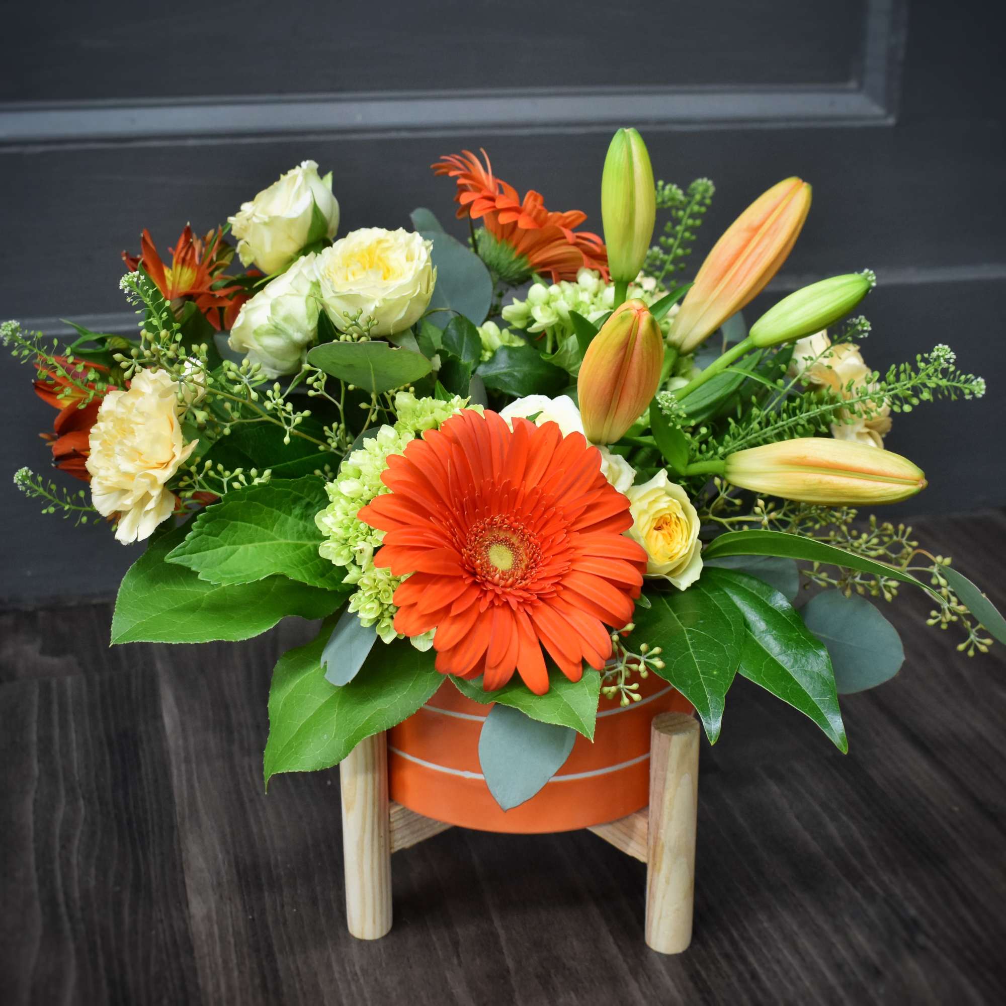 A bold orange gerbera takes center stage in this Sizzlin' Summer Blooms