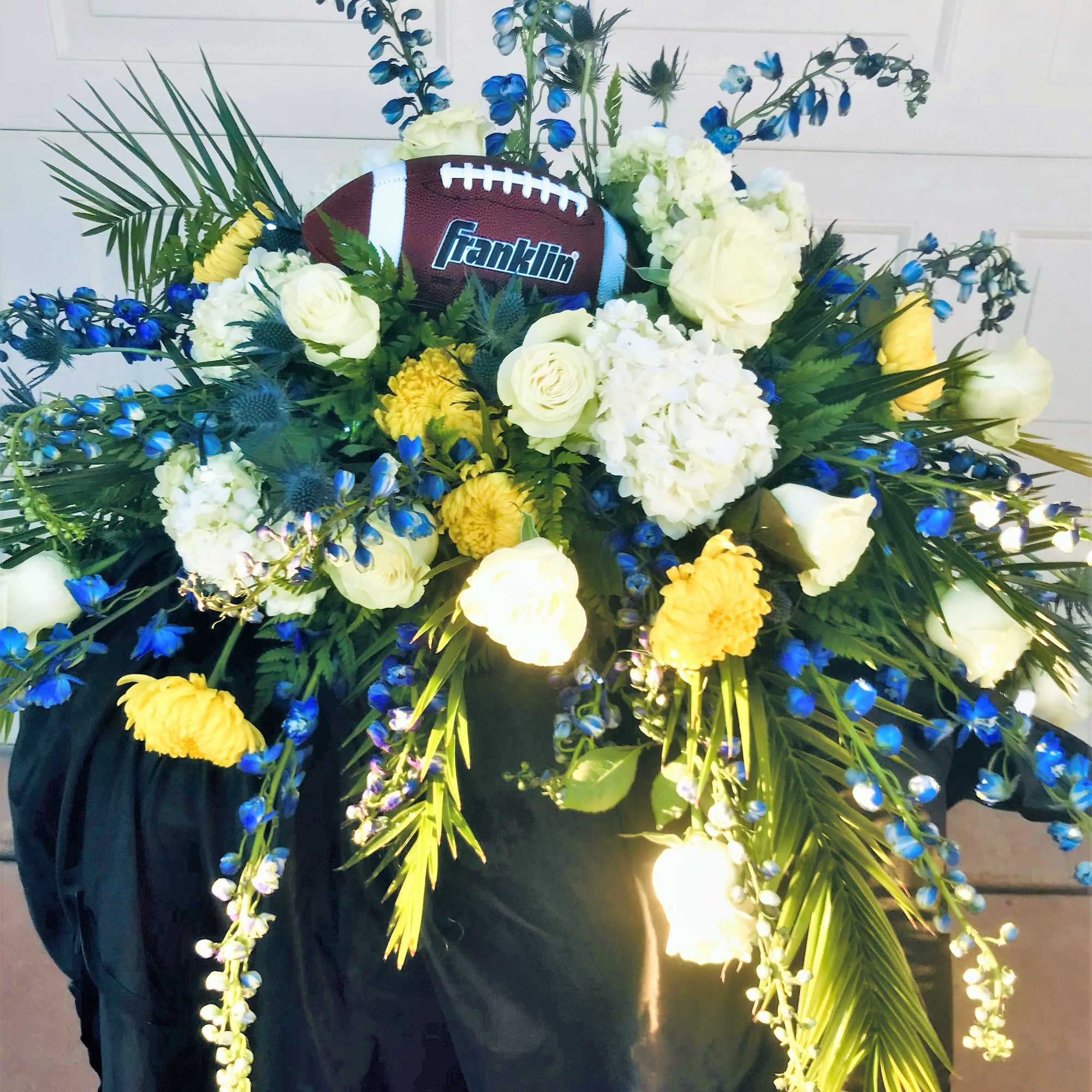 Football-themed floral arrangement with white and yellow flowers