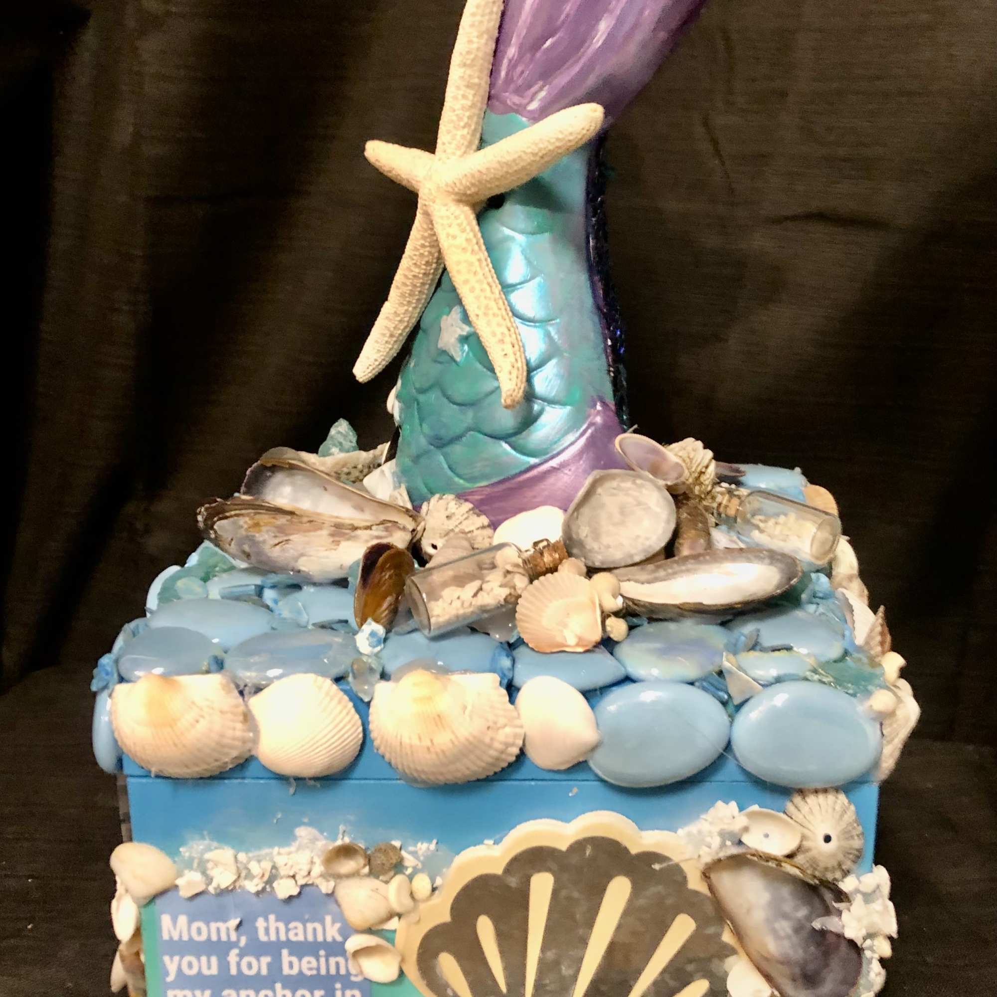 Decorative mermaid-themed gift box covered in seashells and a starfish