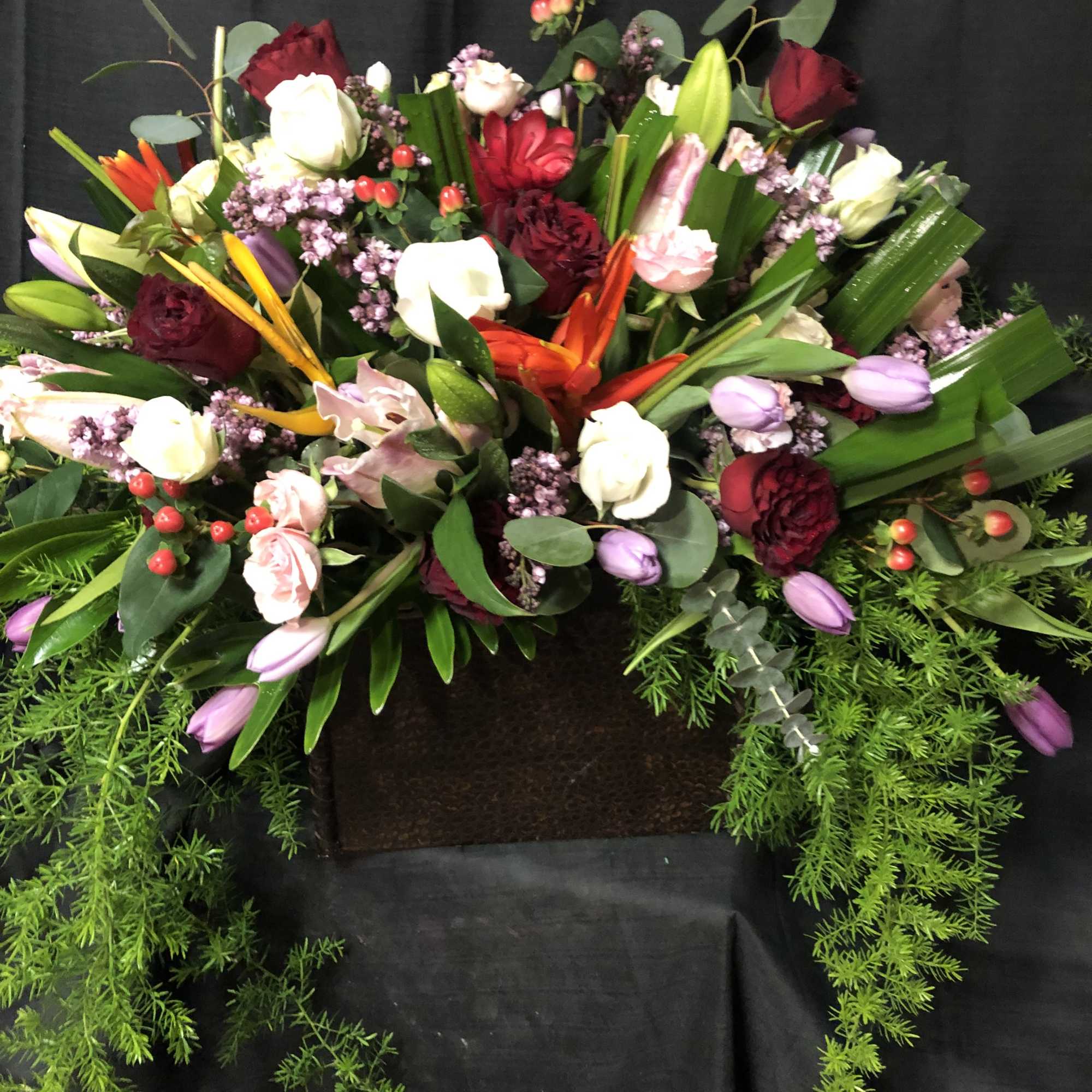 Large mixed floral arrangement with roses, tulips, and lilies