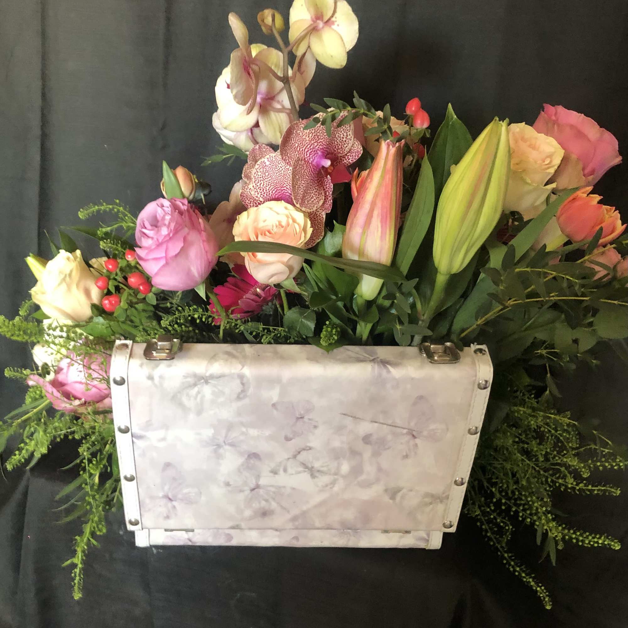 AN ASSORTMENT OF SEASONAL BLOOM IN A SMALL SUITCASE, photo 3 of 3