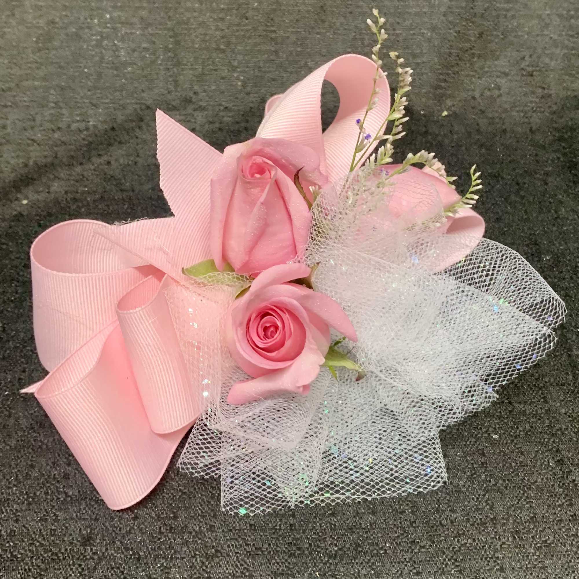 Pink rose corsage with ribbon and white tulle