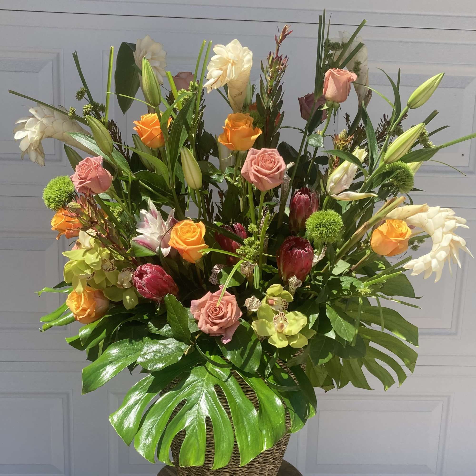 AN EXTRA LARGE TROPICAL FLORAL ARRANGEMENT, PERFECT TO CLEAR AWAY THE SHOWERS